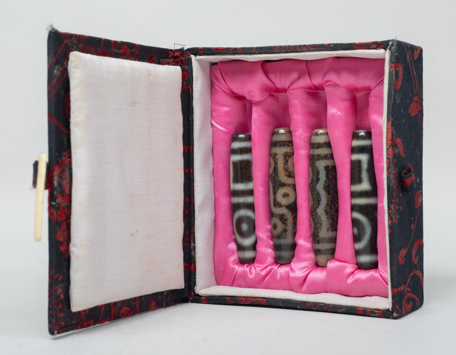 Set Chinese/ Tibetan Long Dzi Beads: Set of four Chinese / Tibetan long dzi beads, with box. Approx. 2.3 inch L (longest). The Estate of E Los Angeles, CA, 2021.