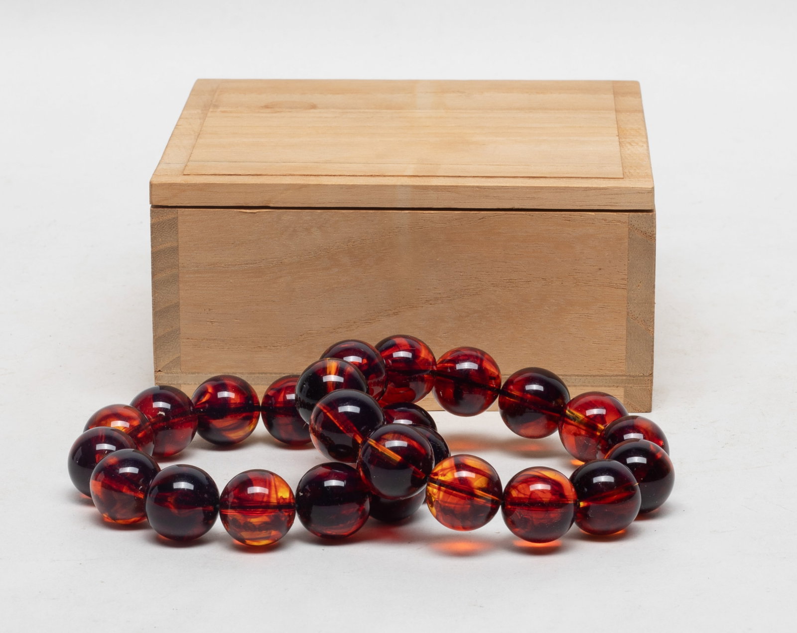 Two Chinese Cherry Amber Prayer Beads: Two strings of Chinese cherry amber prayer beads, with box. Approx. 88 gram (total bead weight), 0.7 inch D (each bead size).