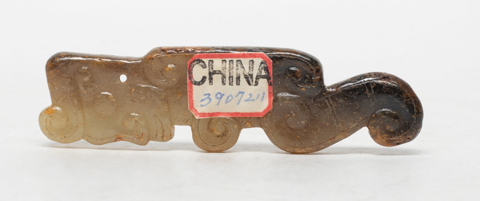 Chinese Russet Jade Pendant: Chinese russet jade pendant worked of archaistic beast form. Approx. 3.62*1 inch.