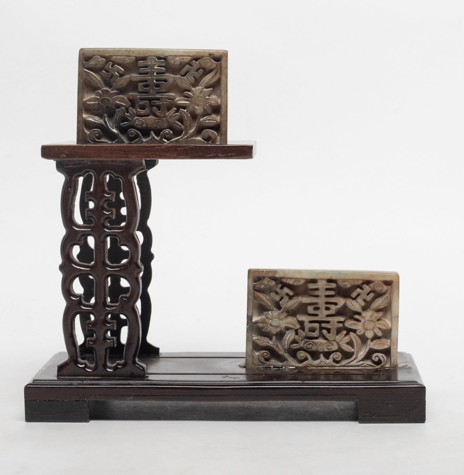 Chinese Ming Type Burnt Jade Plaques on Base: Two Chinese burnt jade plaques carved with Shou characters and lotus, affixed to tall wood stand. Approx. 6.6*6.2*3.2 inch.