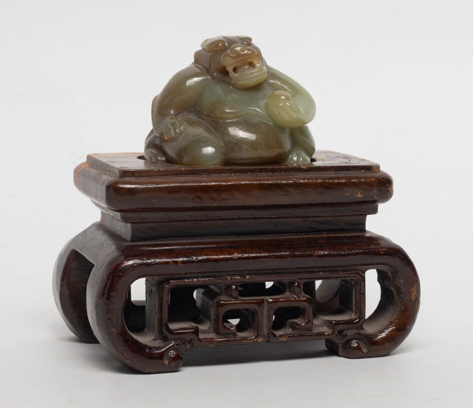 Chinese Russet Jade Sculpture on Base: Chinese russet jade carved stylized beast sculpture, affixed to wood base. Approx. 3.9*3.8*2.4 inch (w/ stand).