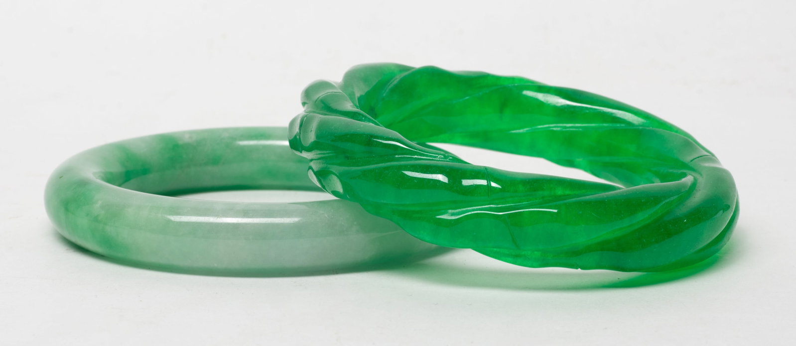Two Chinese Colored Stone/Glass Bangles: Two Chinese colored stone/glass bangles. Approx. 3.3 inch outer diameter, 2.25 inch inner diameter (larger).