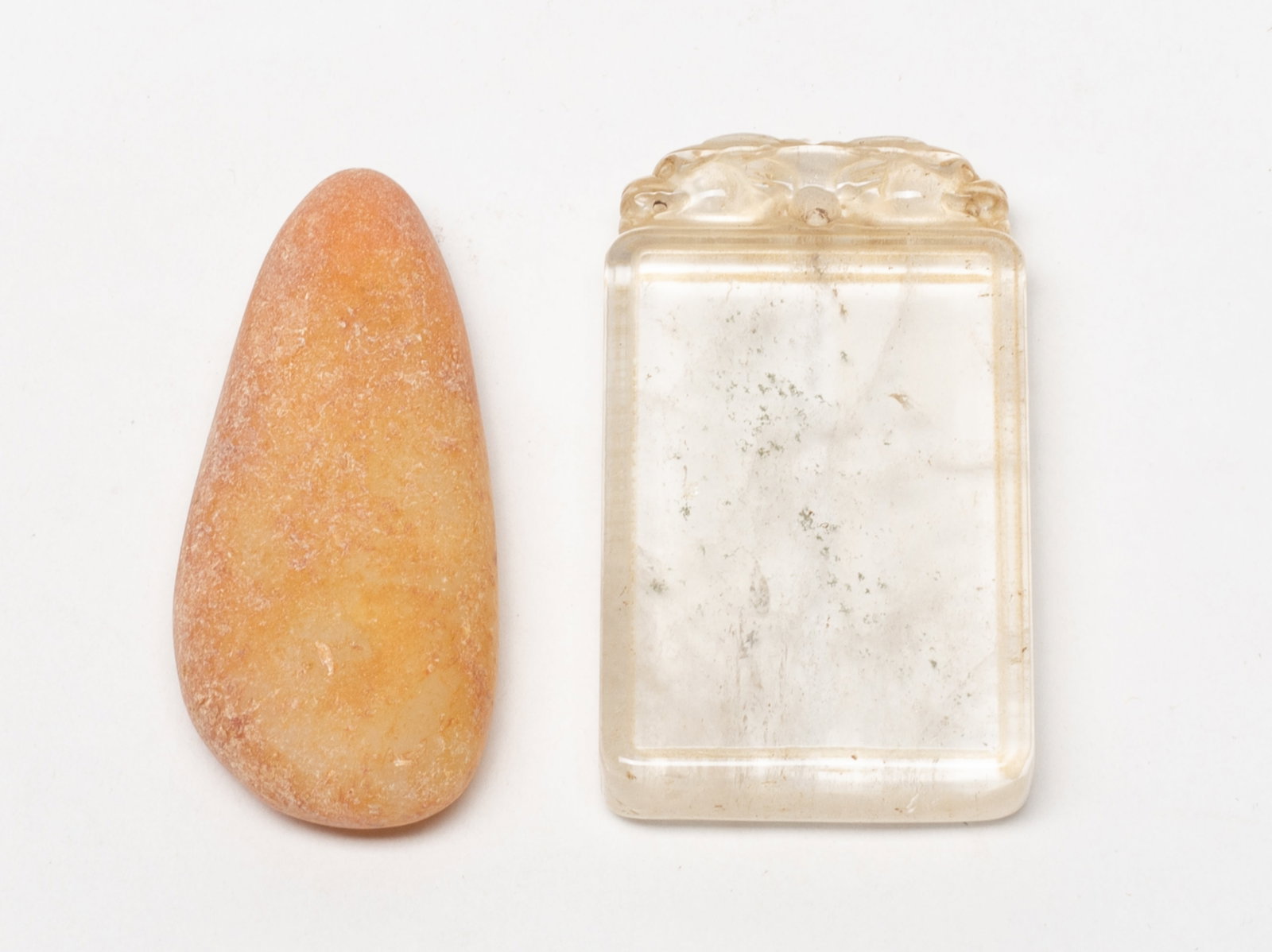 Chinese Rock Crystal & Jade Pendants: Chinese clear rock crystal plaque and russet jade pebble. Approx. 2.77*1.58 inch (plaque size).