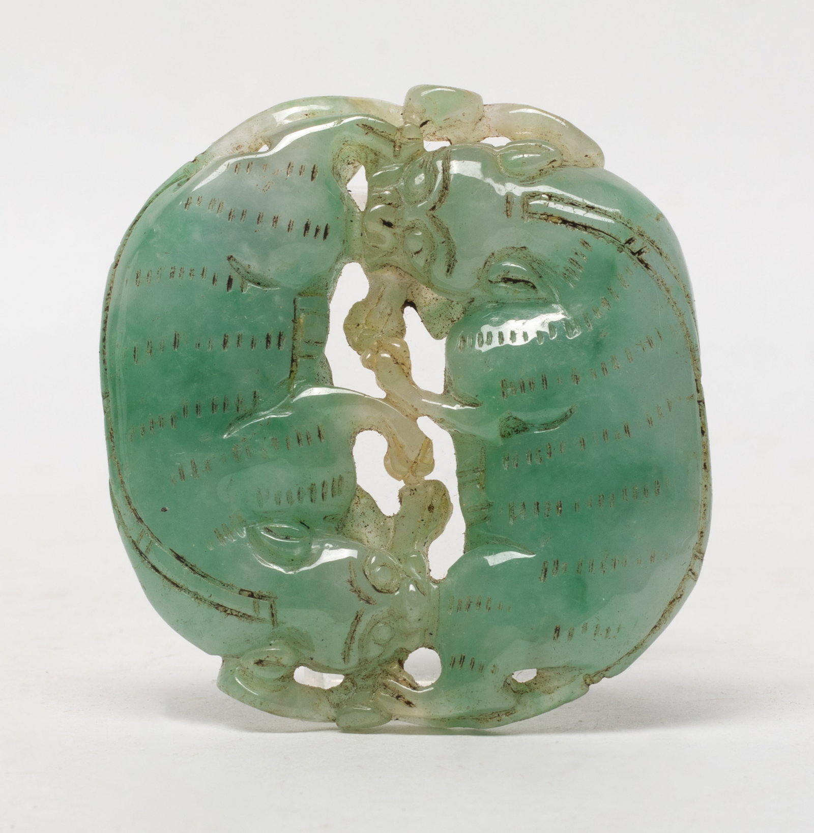 Chinese Jade Beast Pendant: Chinese jade pendant carved as a pair of recumbent beasts. Approx. 2.48*2.3*0.47 inch.