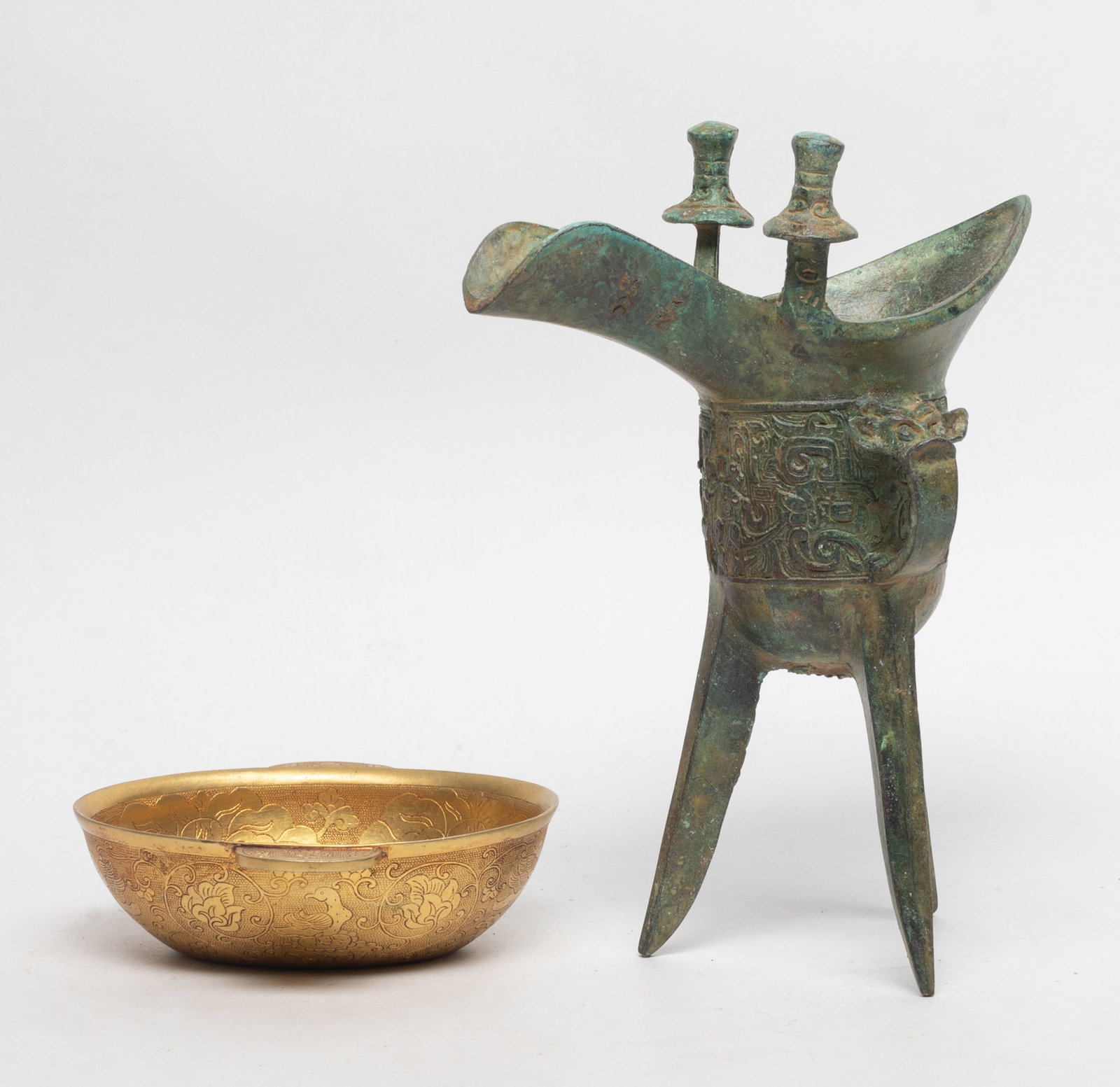 Two Chinese Export Bronze Cups: Two Chinese bronze cups, one of archaic jue form, the other of boat cup form. Approx. 7.6*5.8*3.2 inch (larger).