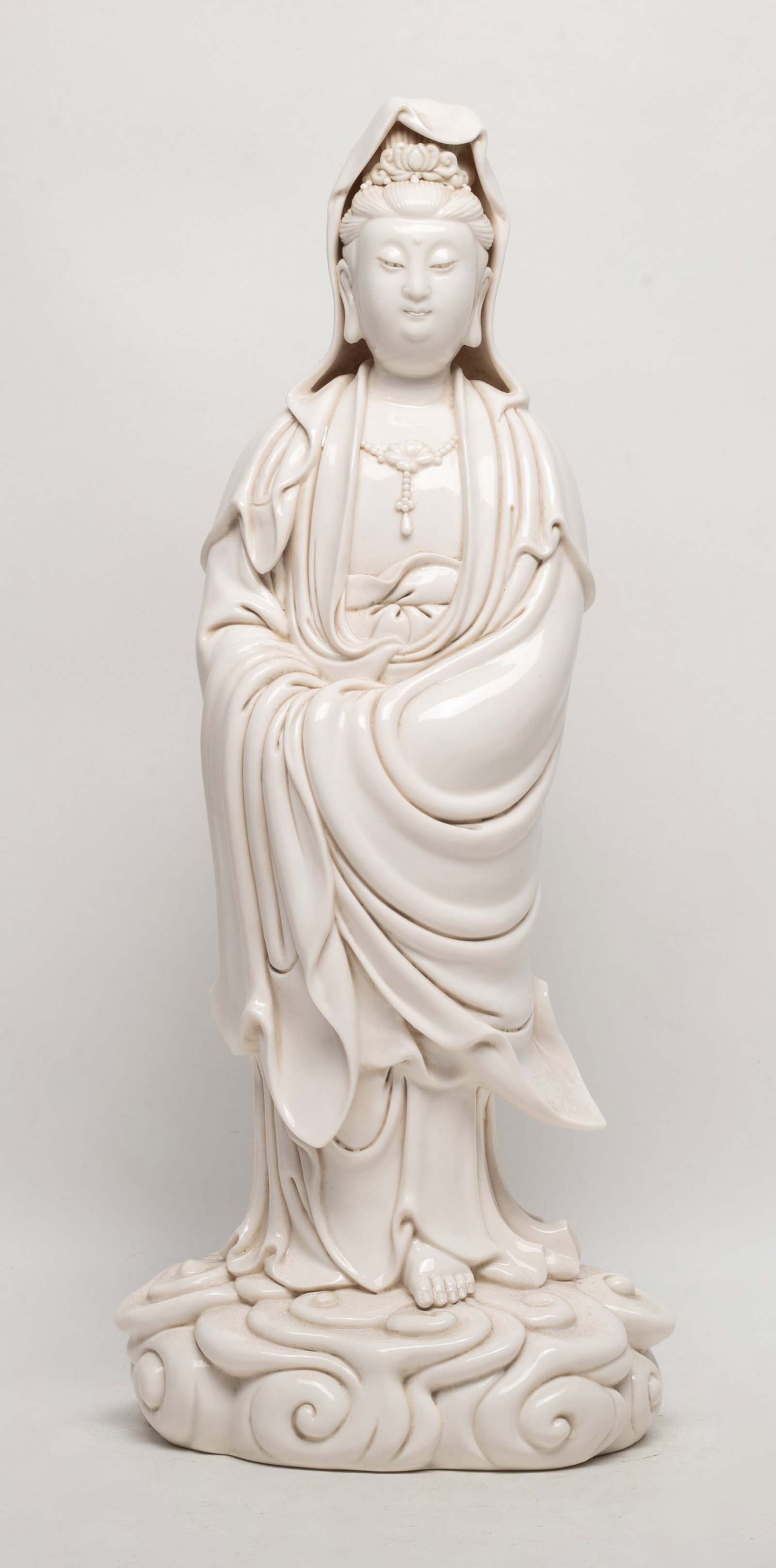 Tall Chinese Blanc De Porcelain Kuanyin: Tall Chinese creamy glazed porcelain sculpture of standing Kuanyin, incised a gourd shaped mark on the back. Approx. 17*7*5.3 inch.