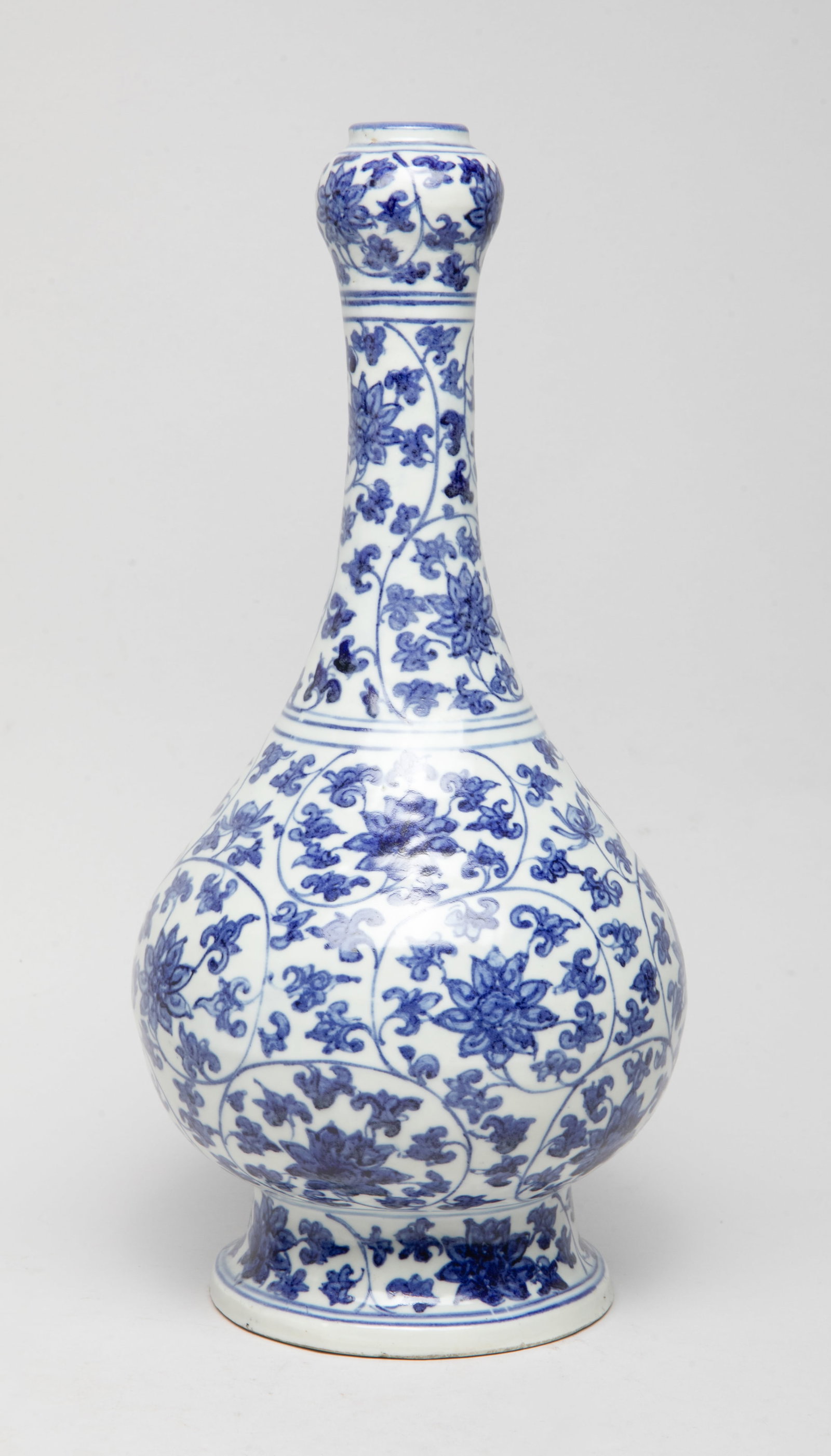 Tall Chinese Shipwreck Form Porcelain Vase: The pear-shaped body rising from a splayed foot to a tall slender neck and a garlic mouth, the exterior decorated with undulating leafy stems issuing louts blossoms. Approx. 12.6*6 inch. The Estate