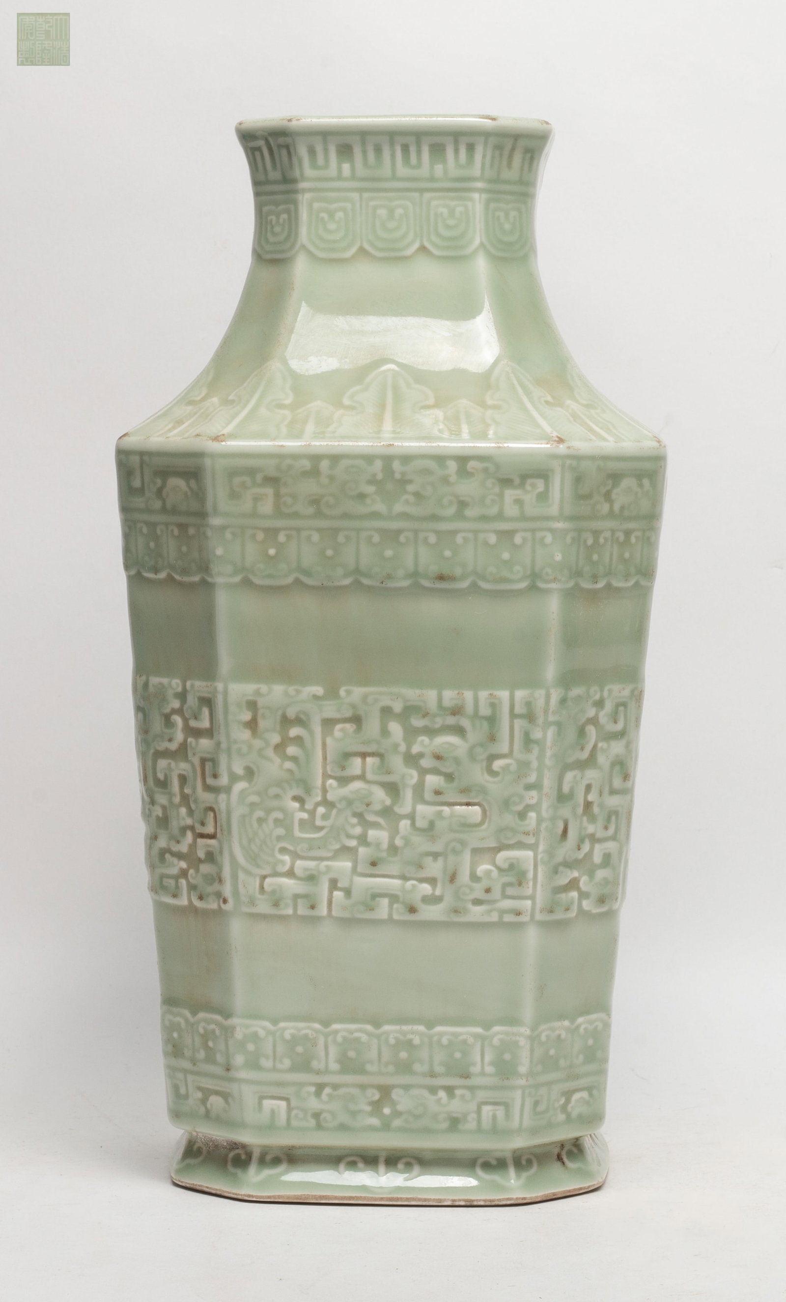 Tall Chinese Bean Green Glazed Porcelain Vase: Chinese bean green glazed porcelain vase carved with archaistic motif, marked six character to the bottom. Approx. 13*6.5*6.5 inch.