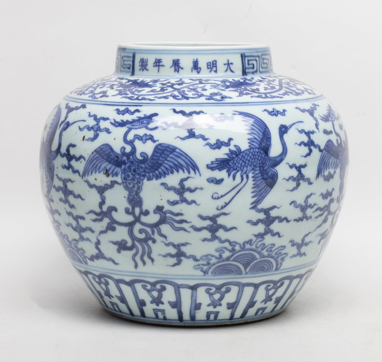 Large Chinese Blue & White Porcelain Jar: Large Chinese blue and white porcelain jar, painted with phoenixes flying amidst clouds, marked six characters at rim. Approx. 8.3*9.7 inch.