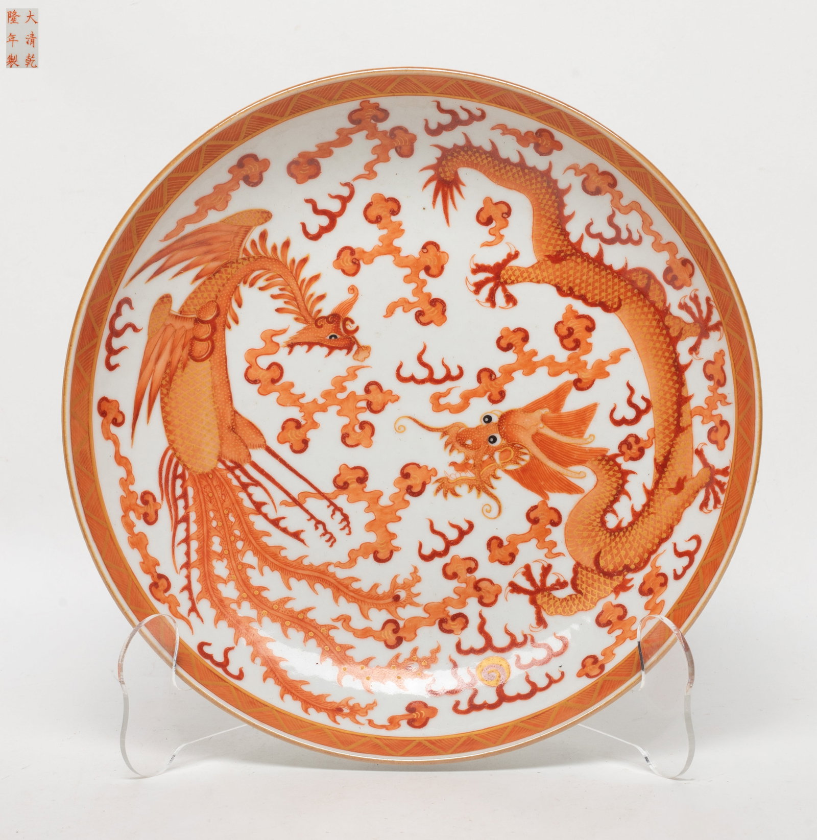 Chinese Coral Red Glazed Porcelain Deep Plate: Chinese porcelain plate painted in coral red with dragon and phoenix among clouds, marked six characters to the bottom. Approx. 8.7 inch D.
