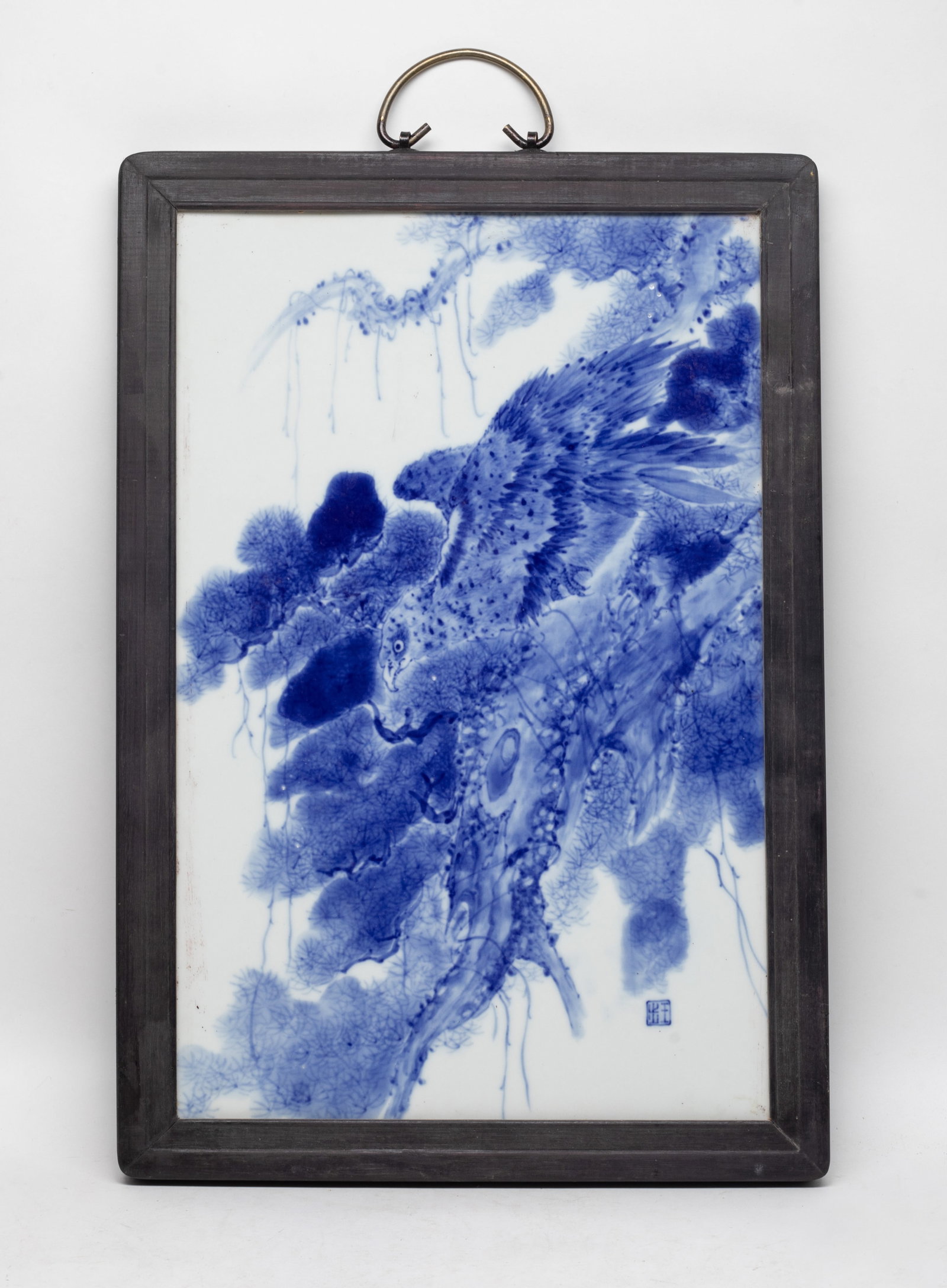 Chinese Blue & White Porcelain Hanging Plate: Chinese blue and white porcelain painted with a hawk perched on a pine tree, framed in a wood. Approx. 13*19.1 (with frame)