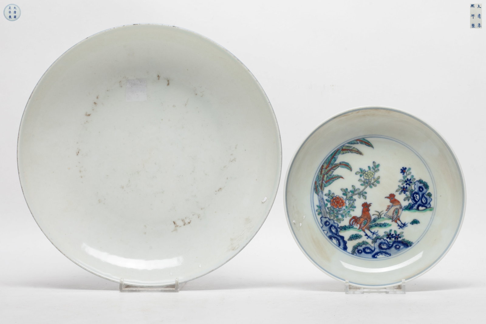 Two Chinese Export Porcelain Plates: One plate blue glazed, the other plate painted with roosters and flowers, each bottom marked two characters. Approx. 8.7*1.7 inch (larger).