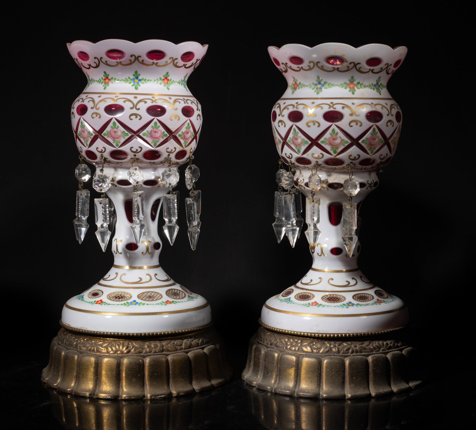 Two Early 20th Cut Bohemia Glass Lamps: A pair of vintage Bohemian white overlay cut to cranberry glass mantel luster, featuring hand painted floral and hanging prisms. Approx. 13.1*7.3 inch