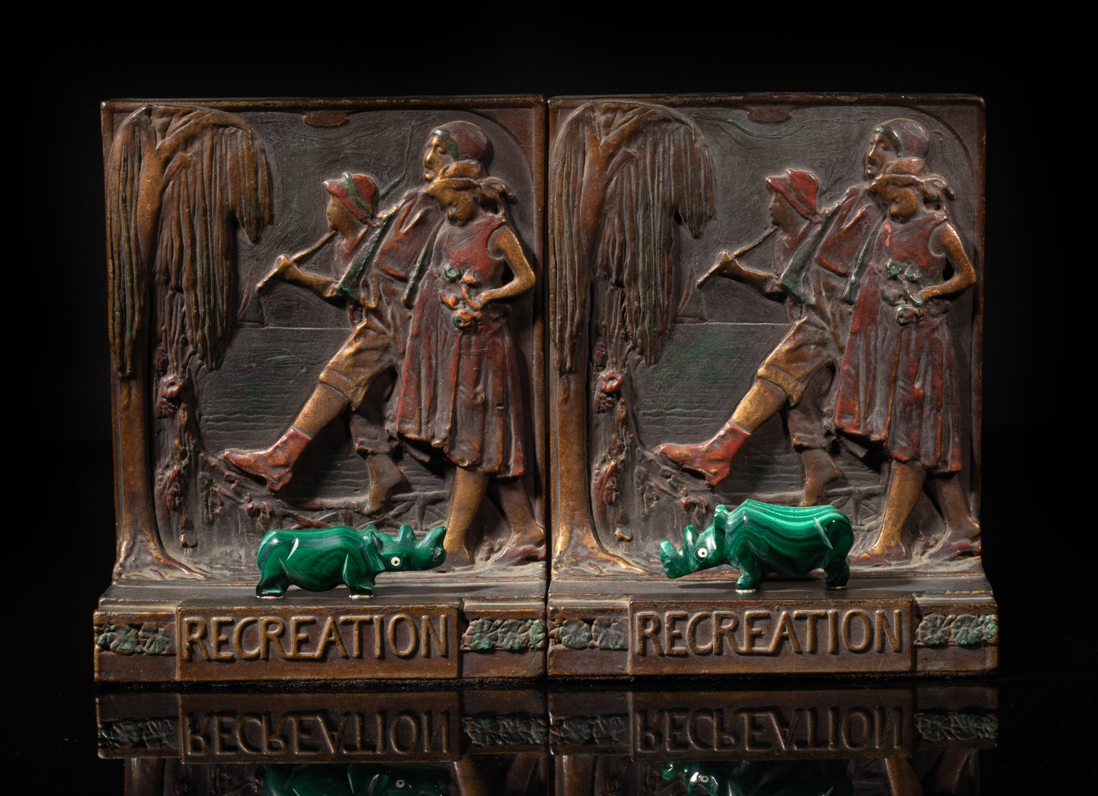 Early 1900s Brass, Malachite Bookends: Two vintage brass bookends cast with figures, decorated with malachite carved rhino sculptures. Approx. 6.3*5*2.6 inch. The Estate of S Pasadena, CA, 2005.