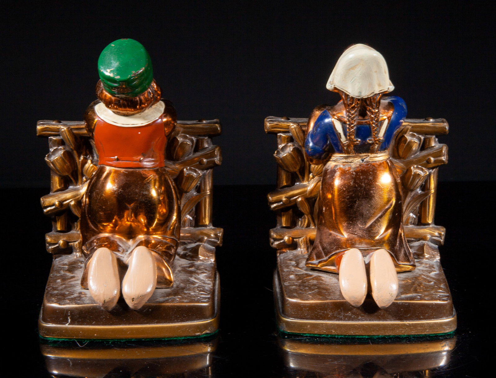 Two 1900-30s Painted Bronze Bookends: Two vintage painted bronze bookends, moulded as a boy or a girl kneeling along flower fence and looking forward. Approx. 5.5*4*3.9 inch (larger). The Estate of the Huntington Beach, CA, 1999.