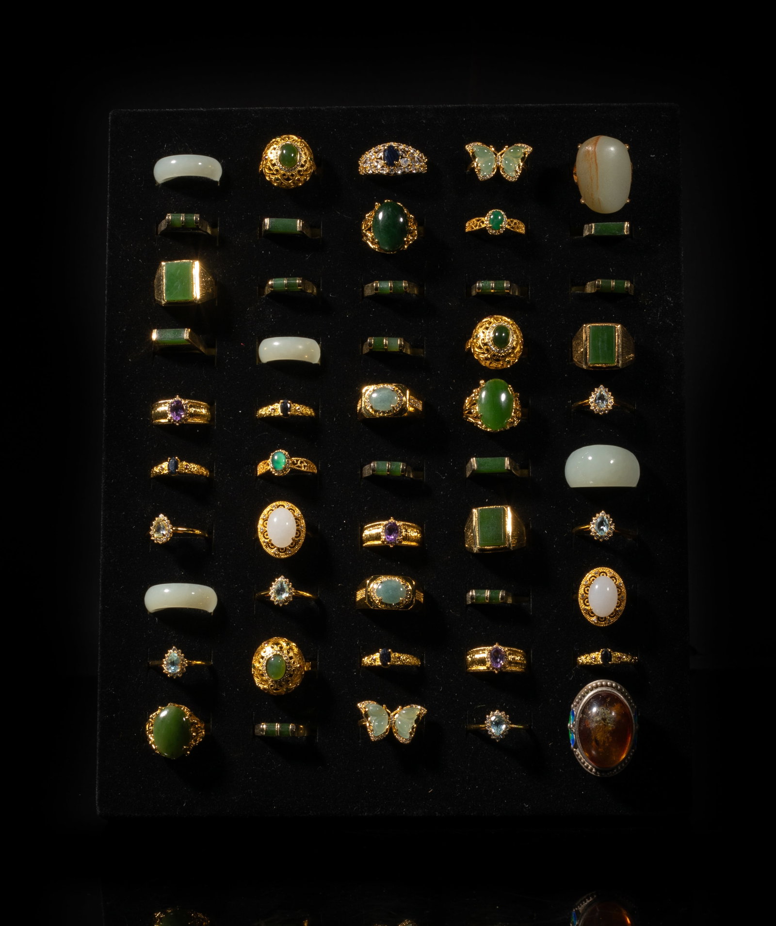 Set Chinese Jade, Gemstones Rings: Large set of Chinese designed jade and gemstone rings, with display stand. Size varies.