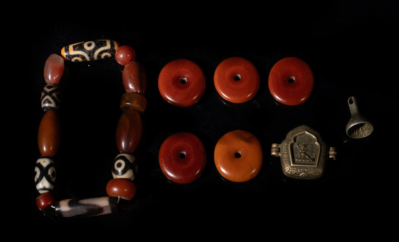 Estate Chinese Tibetan Dzi, Amber, Brass Beads: Chinese Tibetan dzi beads, amber beads and brass beads. Size varies. The Estate of the Pi Sum Park. Newport Beach. 1995.