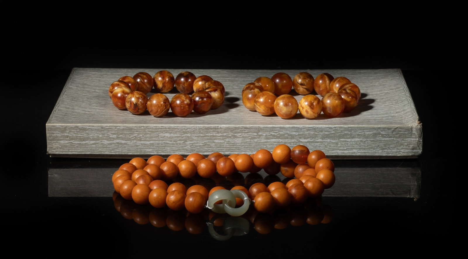 Chinese Export Amber Prayer Beads, Necklace: Including an amber bead necklace and two amber prayer bead bracelets, with box. Approx. 24 inch L (necklace size). The Estate of the Jenny Park. Little Tokyo. Los Angeles. 1992.
