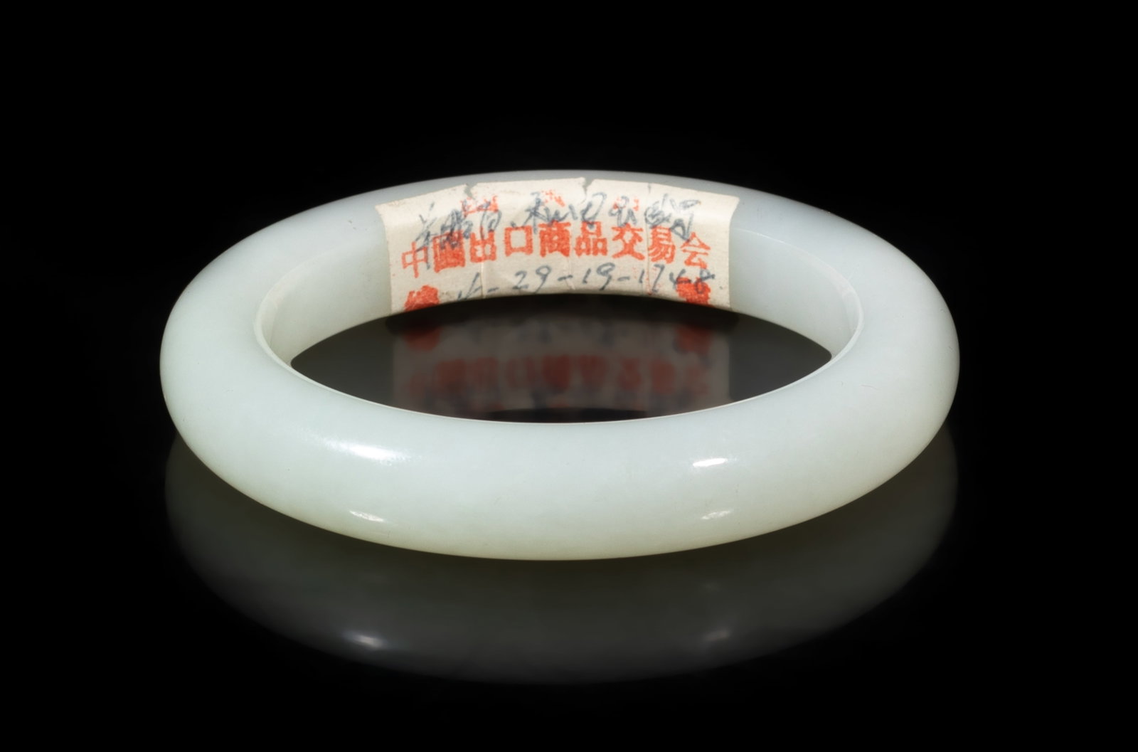 Vintage Chinese 1950-70s Export White Jade Bangle: Chinese 1950-1970's white jade carved bangle. Approx. 3.17 inch outer diameter, 2.33 inch inner diameter. The Estate of the Store Closed Sale, Downtown Los Angeles. 2020.