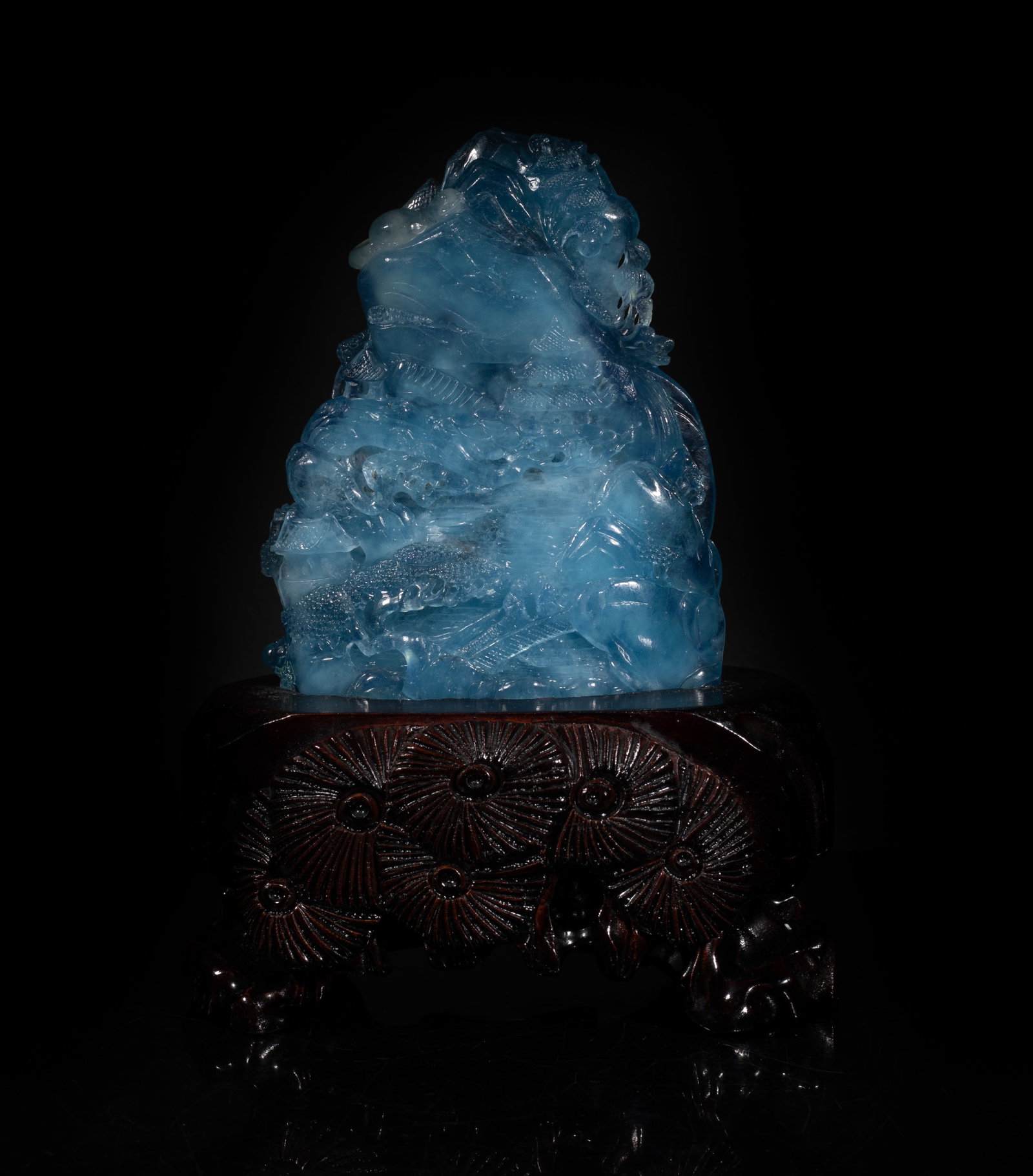 High Quality Chinese Aquamarine Sculpture: Chinese aquamarine sculpture carved with mountain landscape, with wood stand. Approx. 8.2*6.1*3.5 inch (w/ stand). The Estate of Royal Duff Art. NYC. 1990.