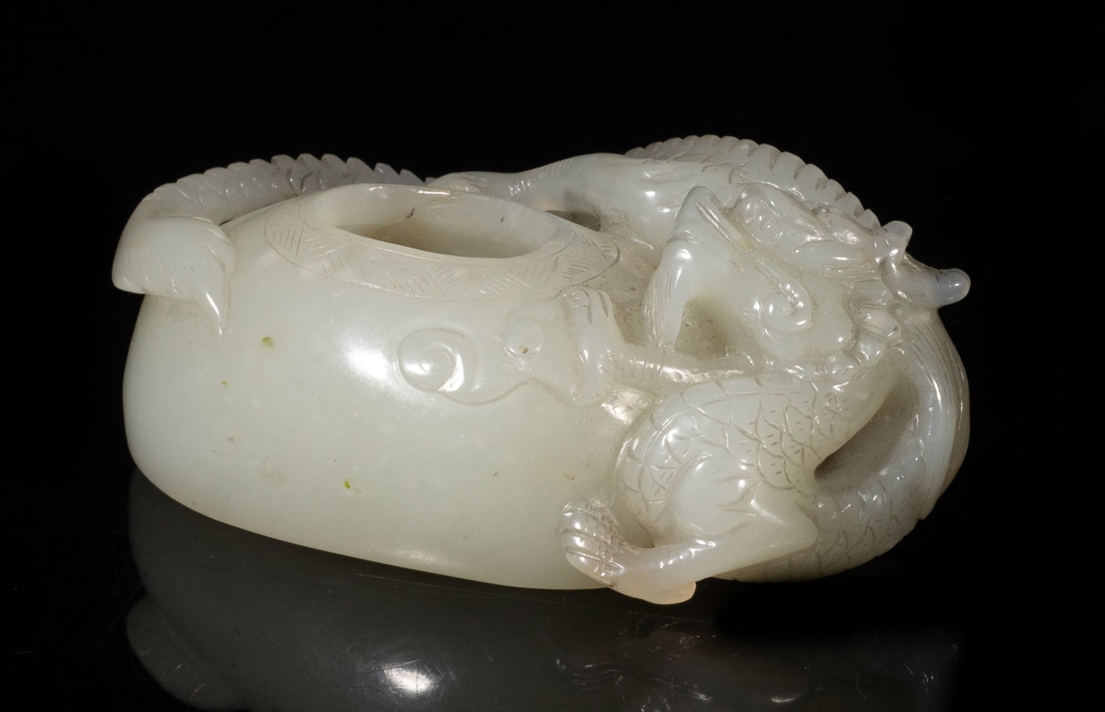 Chinese White Jade Carved Dragon Water Pot: Chinese white jade water pot carved in high relief with a sinuous dragon. Approx. 3.4*2.1*1.3 inch. The Estate of the Jen & Son. Newport Beach. 2001.