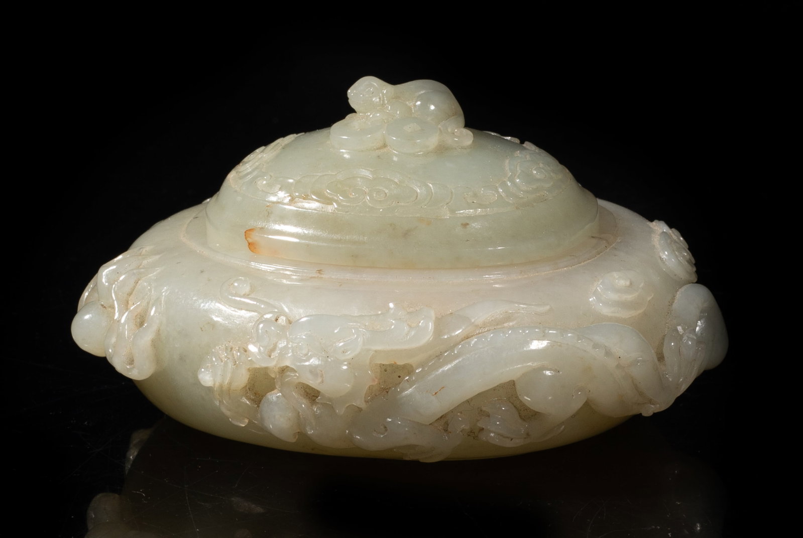Chinese Jade Carved Covered Pot: Chinese jade covered pot carved with dragons, the lid carved with mouse and coins. Approx. 4.1*3.6*2.1 inch. The Estate of the Peter Lao. HK. 1995.