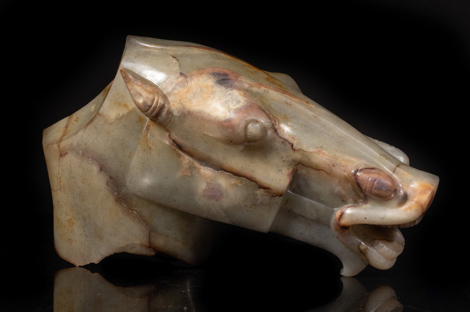 Rare Chinese Russet Jade Horse Head: Large Chinese russet jade horse head sculpture, incised with ancient characters. Approx. 7*4.5*2.4 inch. The Estate of the Coen & Jonah. AZ. 1990.