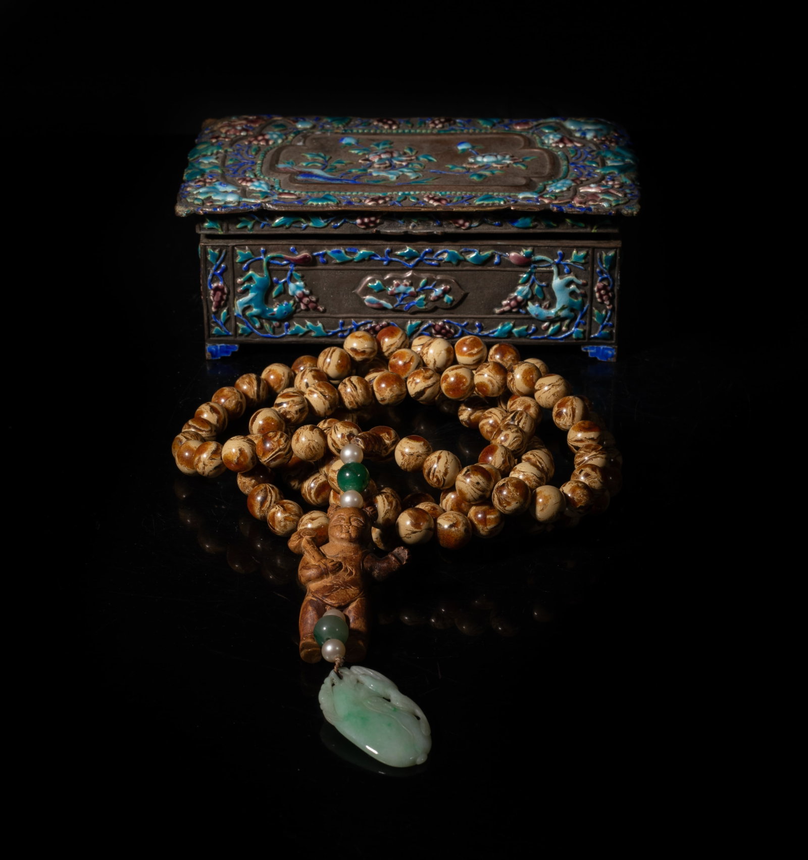 Late Ching Type Chinese Amber, Jade Prayer Beads: A long string of Chinese amber carved prayer beads, with jade and wood carved pendants, with an enameled box. Approx. 50 inch L (string size). The Estate of the Jenny Park. Little Tokyo. Los Angeles. 