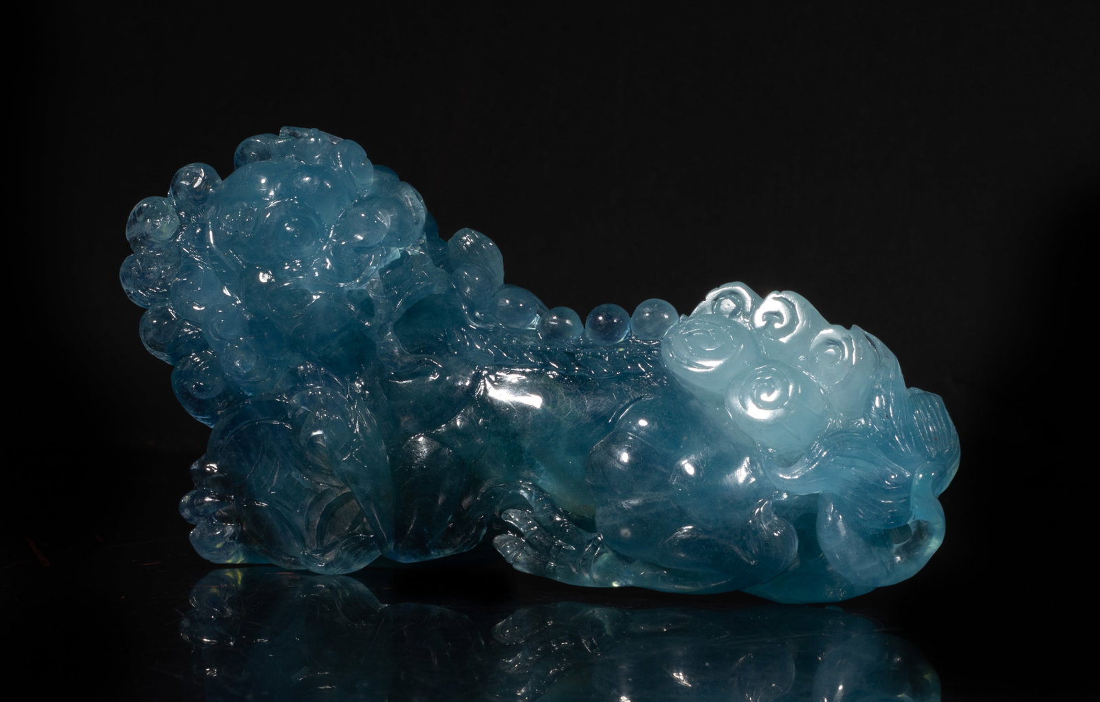 Large Chinese Clear Aquamarine Sculpture: The sculpture applied in the ice-blue tone, in the form of the beast, it features a ferocious, lion-like face with bulging eyes, a broad snout, and an open mouth. Approx. 4.99*2.71 inch