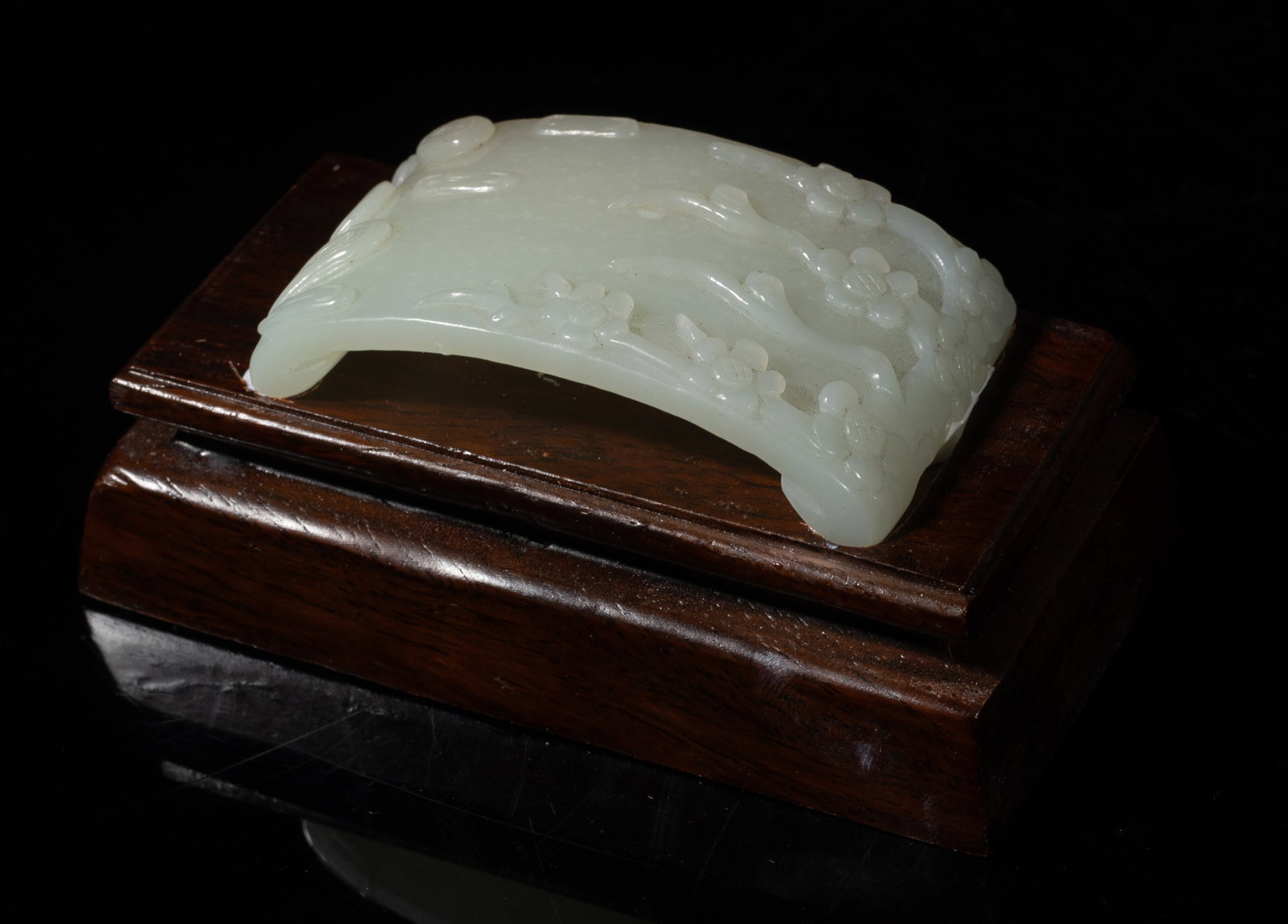 Estate Chinese White Jade Brush Stand: Chinese white jade brush stand carved with plum blossoms, affixed to stand. Approx. 4.3*2.3*1.88 inch (w/ stand). The Estate of the J. T. Chang. HK. 1992.