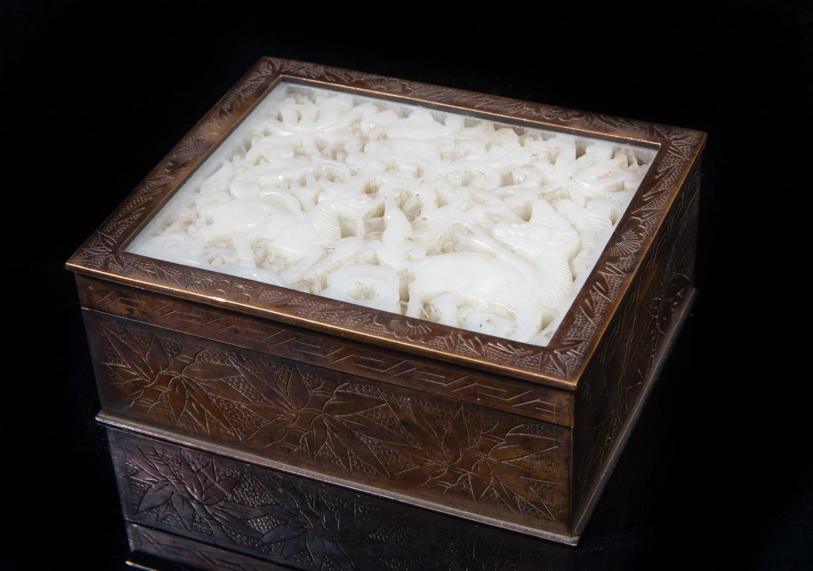 Estate Chinese Brass Box Inlaid Jade Plaque: Of rectangular shape, the sides incised with bamboo, the box interior incised with flowers, inlaid with a jade plaque on the top, carved in openwork with two beasts among foliage. Approx. 4*3.3*1.6 in