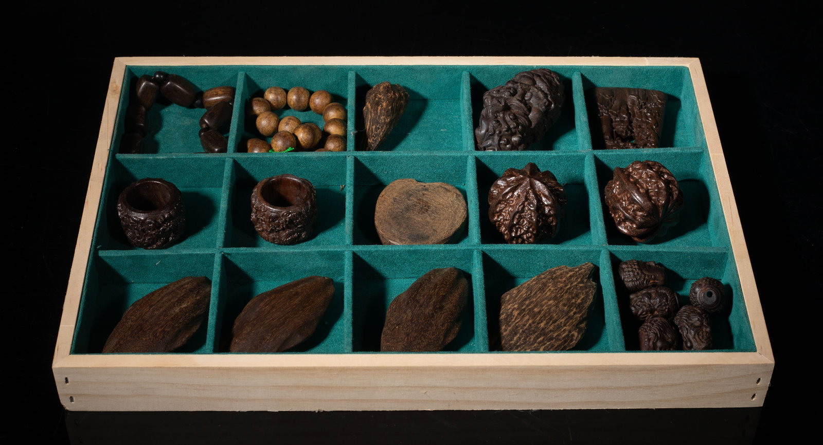Estate Set Chinese Agarwood Carvings: Collection of Chinese agarwood carved beads, thumb rings, toy nuts, pendants, and bead bracelets, with tray. Approx. 435 gram (total wood weight), 3.1*1.6*1.5 inch (largest piece). The Estate of the S