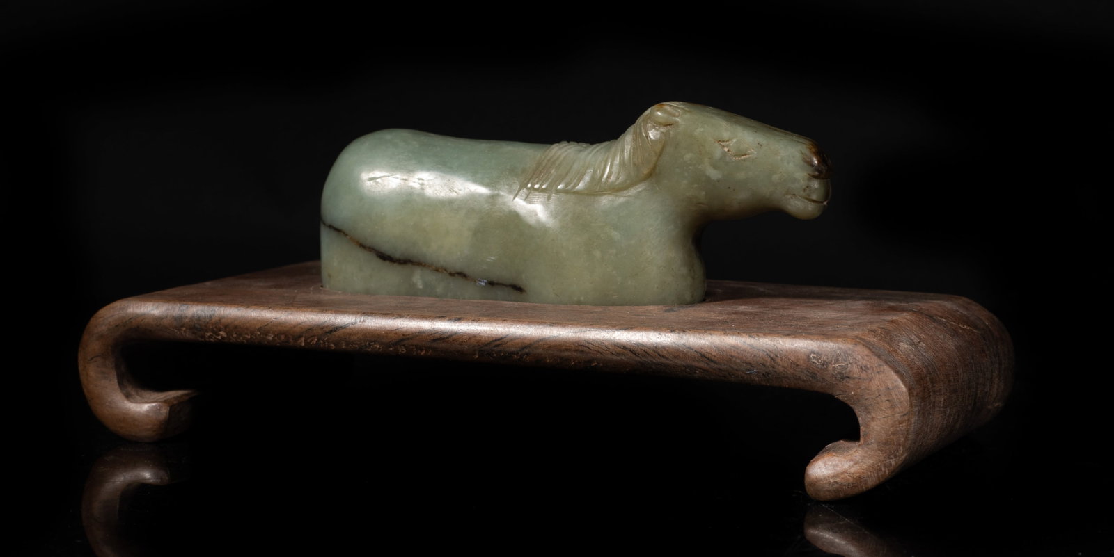 Chinese Early Style Jade Horse on Wood Base: Chinese russet jade carved horse sculpture, affixed to a wood base. Approx. 6.8*3.2*2.6 inch (w/ stand). The Estate of the J. T. Chang. HK. 1992.