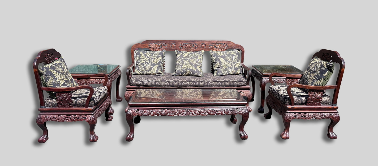 Chinese Rosewood Living Room Furniture Sets: A set of rosewood Chinese living room furniture, including a three-seated sofa, two armchairs, one coffee table, and two side tables, each piece carved in high relief with sinuous dragon motifs and
