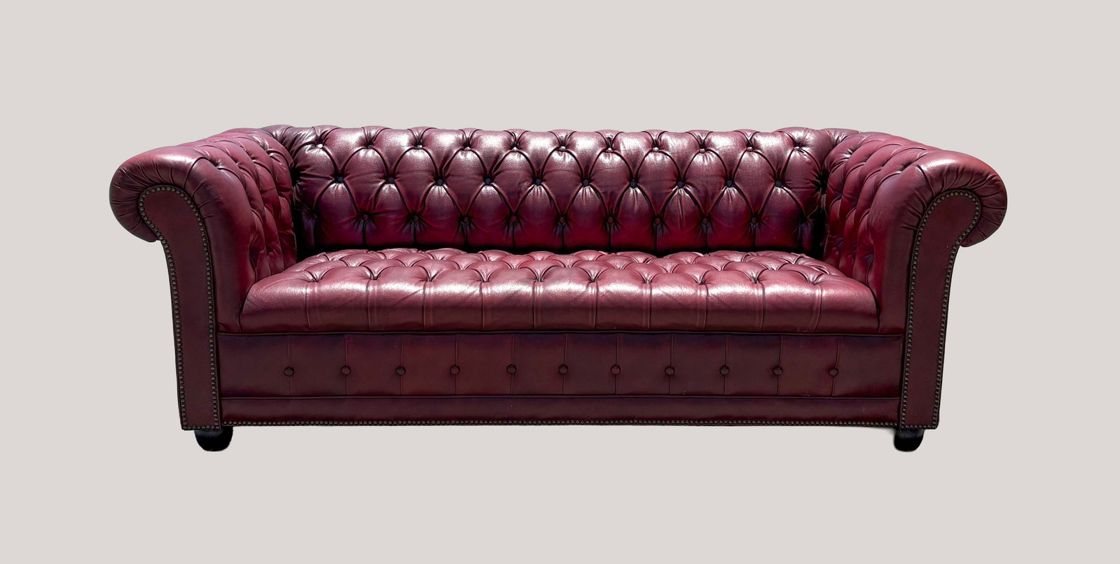 Oxford Red Leather Chesterfield Sofa: The classic Oxford red leather Chesterfield sofa featuring signature deep button tufting, rolled arms, and nail head trim. Approx. 75.5*31*28 inch