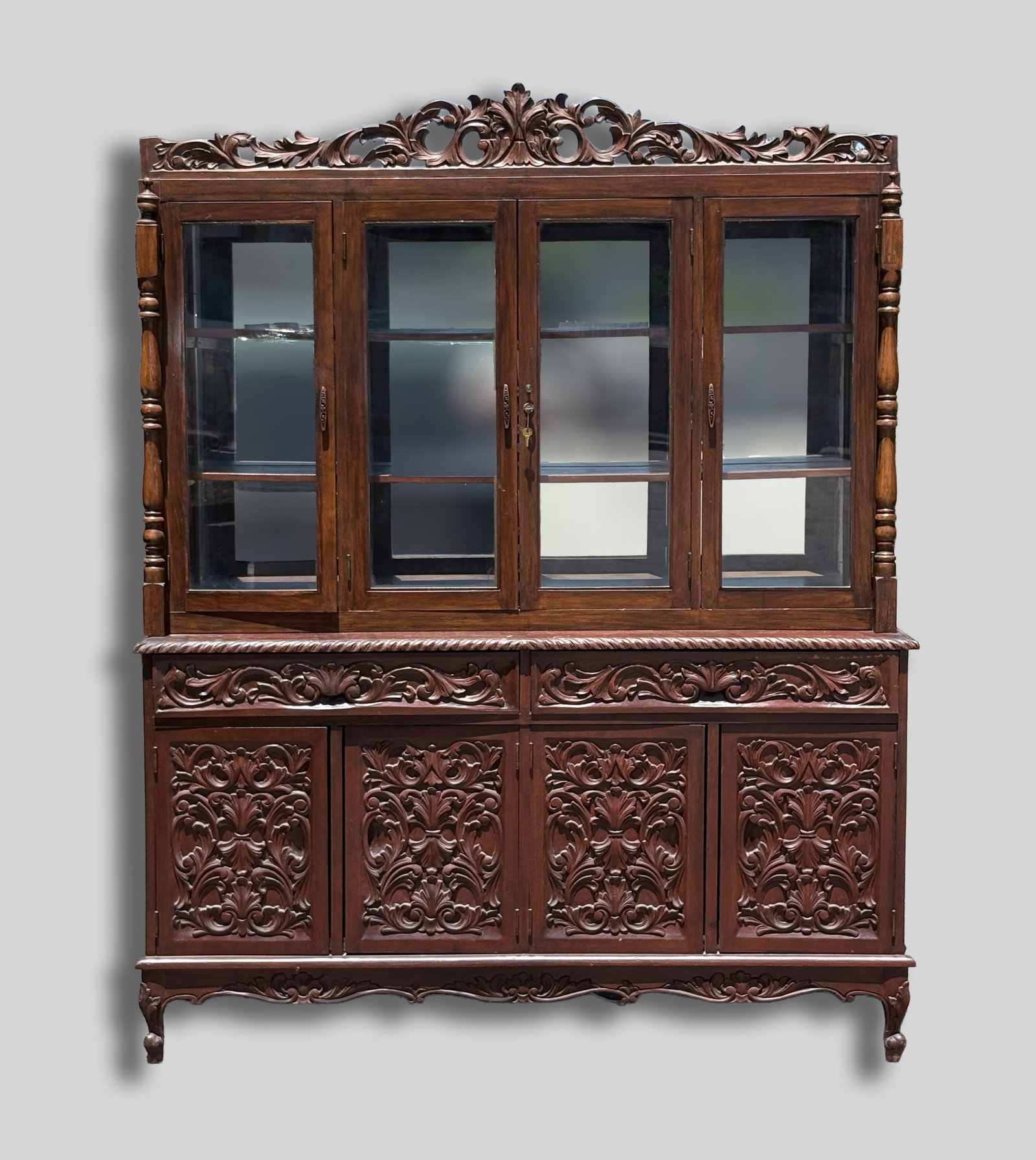 Tall Grand Flemish Renaissance Style Curio Cabinet: The cabinet comes with two-piece wood display, the upper section features a four glass door, an ornate, openwork leafy scrolls on atop, and the lower section decorated with four wood doors, all