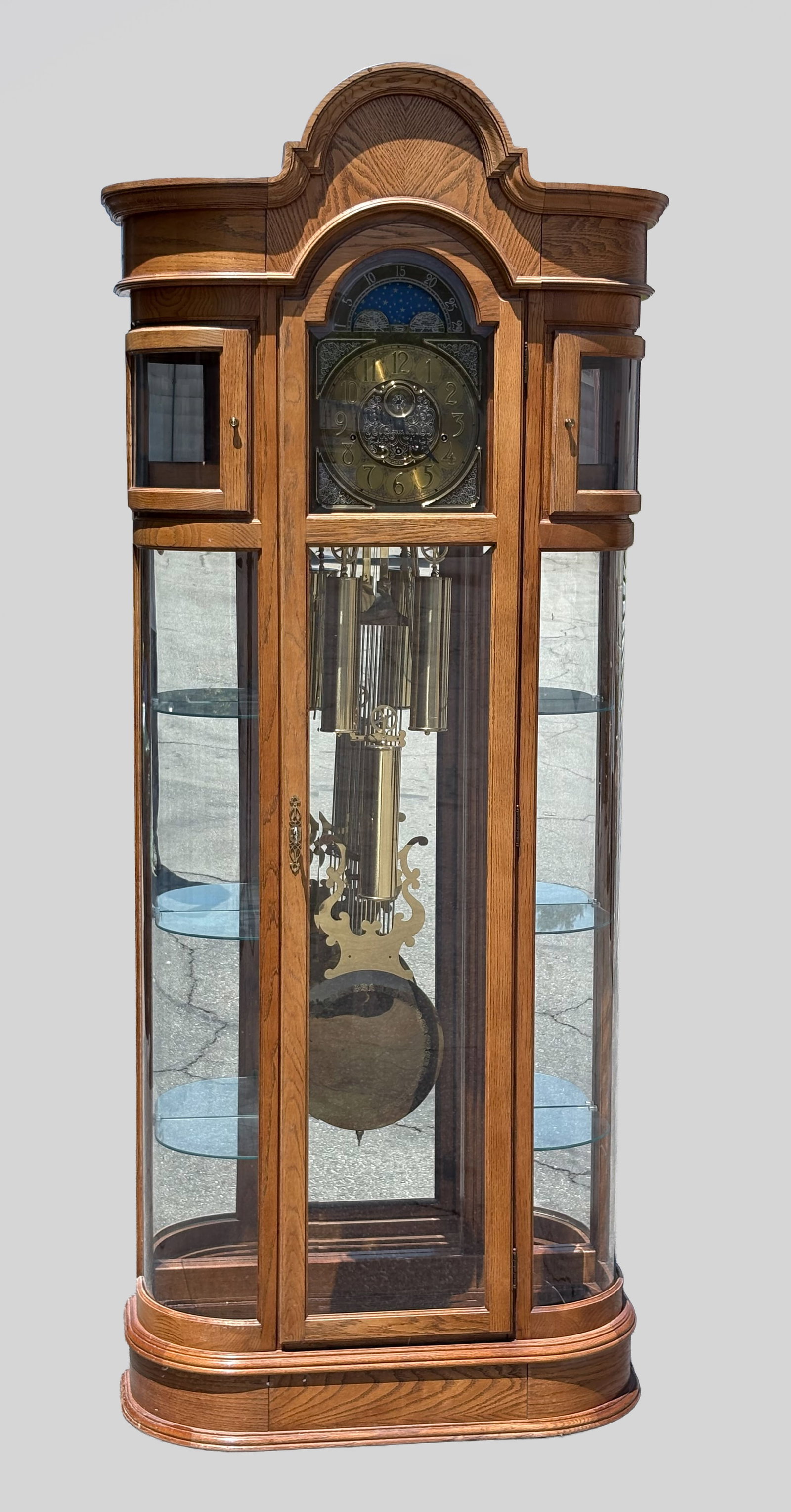 Tall Vintage Ridgeway Grandfather Clock: A Ridgeway grandfather clock made of high quality oak wood with curved glass doors, the composite function of the display cabinet. Approx. 85*32.5*11 inch