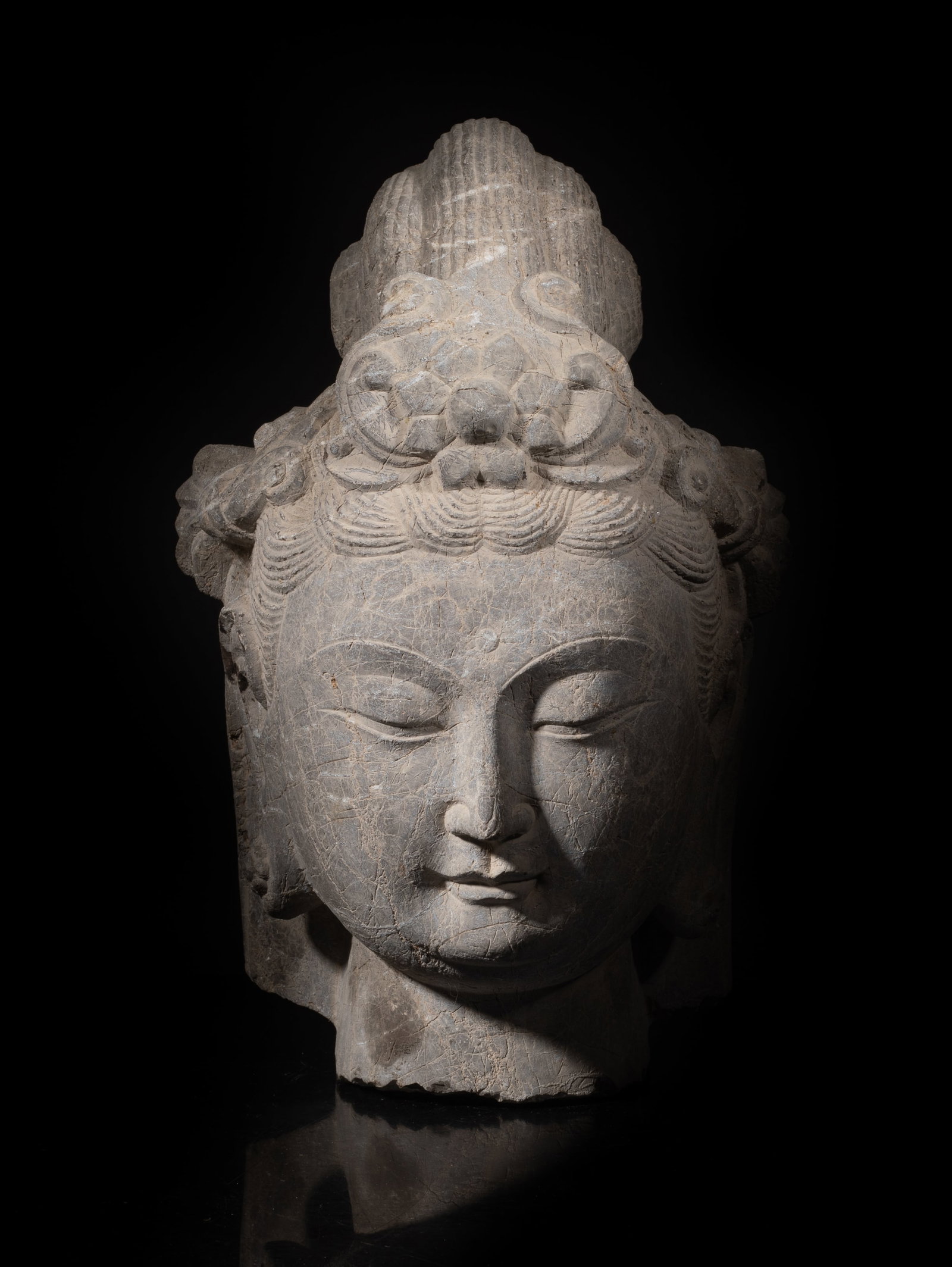 Large Chinese Early Type Stone Buddha Head: The buddha head with a serene expression, down cast eyes, full lips, delicate nose, elongated earlobes and curls. Approx.25*29.5 inch