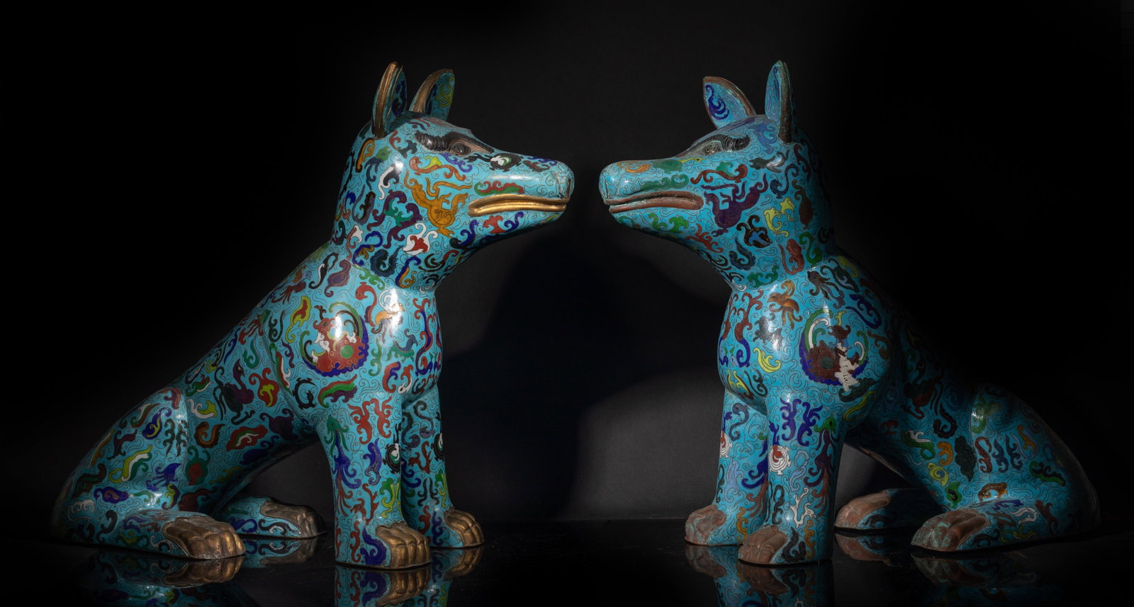 Two Large Chinese Cloisonne Sculpture of Dog: Two large Chinese cloisoone dog sculptures, enameled with traditional patterns on turquoise glazed body. Approx. 22*20*8.5 inch (each).
