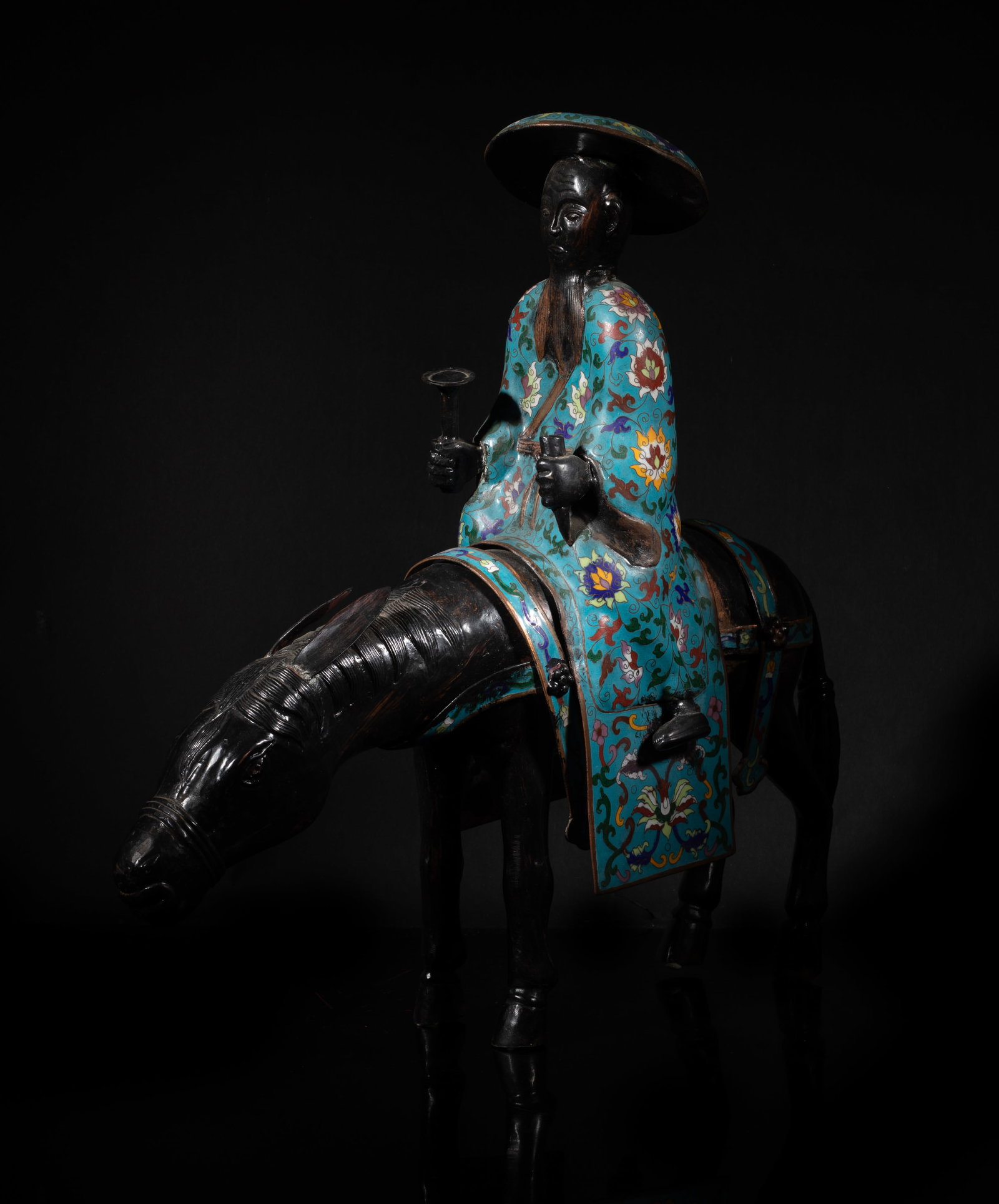 Tall Chinese Clossione Scholar Sculpture: The sculpture depicts a scholar riding a mule, he is seated upright, wearing a flat, wide-brimmed conical scholar's hat, the mule with its head and neck lowered toward the ground. Approx. 17.1*17.5