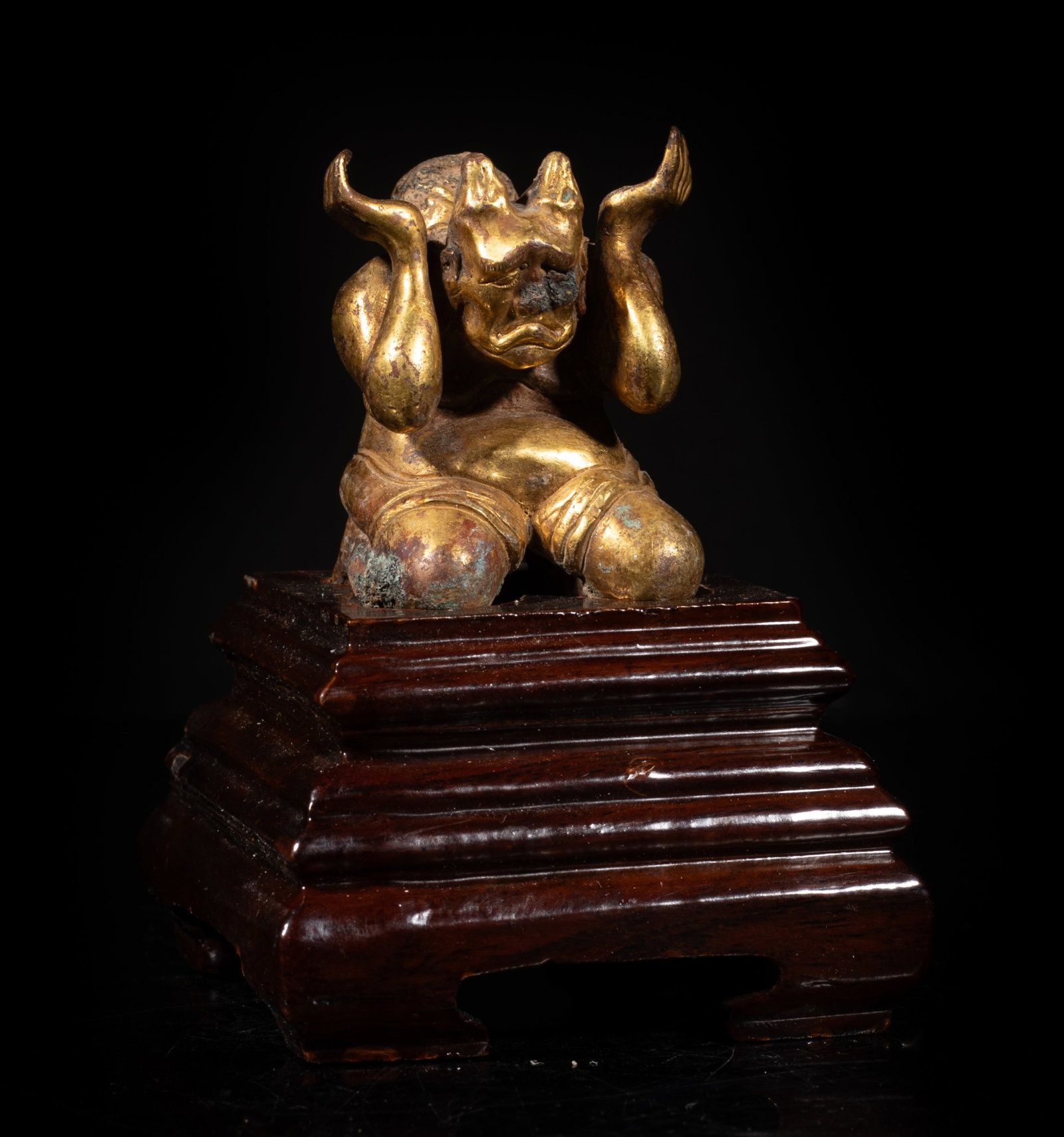 Chinese Gold on Bronze Sculpture: Chinese gold on bronze table sculpture of stylized kneeling figure form, affixed to wood base. Approx. 4*2.9*2.9 inch (w/ base). The Estate of Johnston & Son. 1998.