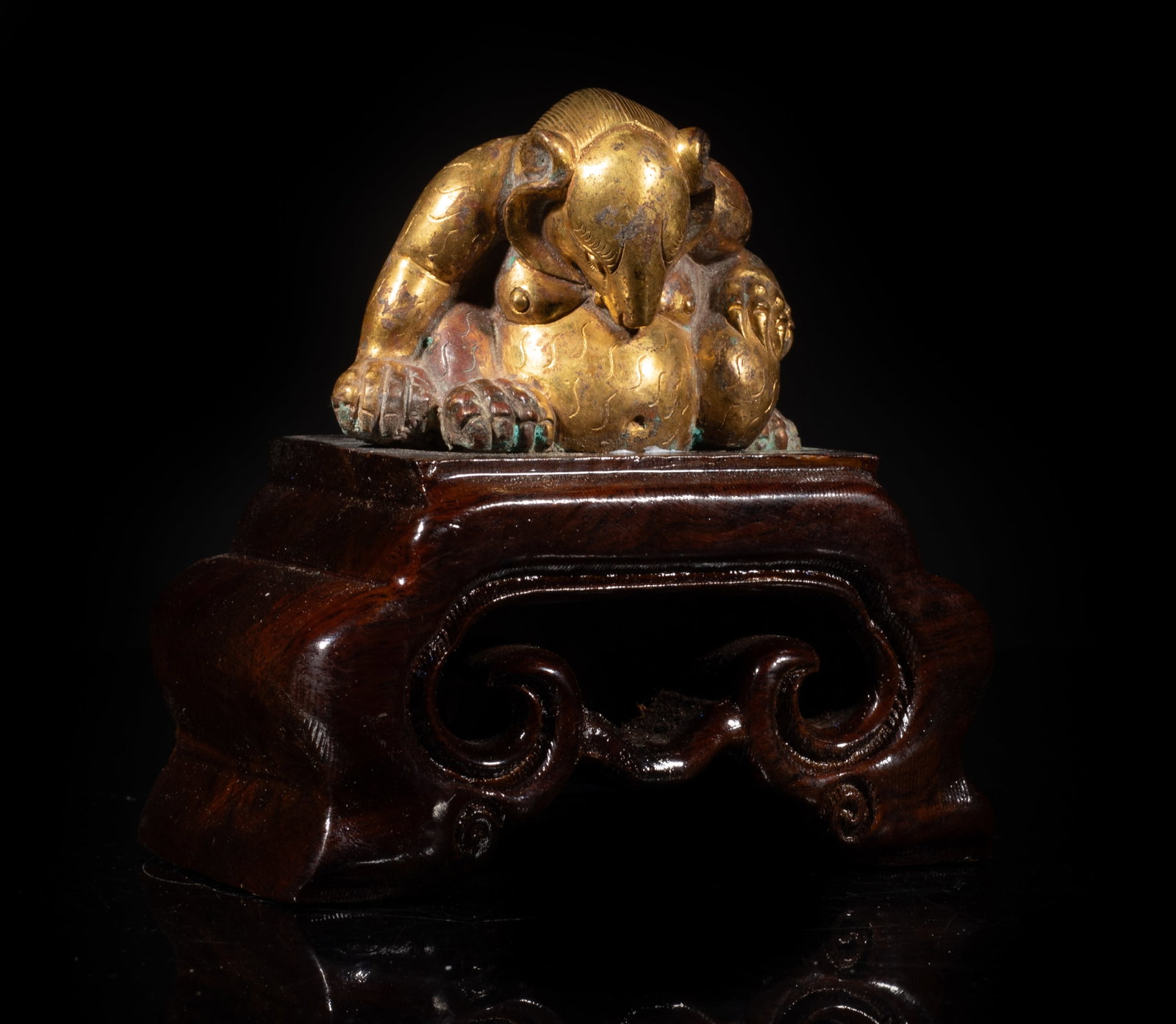 Rare Chinese Gold on Bronze Sculpture: Chinese gold on bronze sculpture of stylized beast form, affixed to wood base. Approx. 4*4*2.3 inch (w/ stand). The Estate of the Mark Oliver. Los Angeles. 1998.