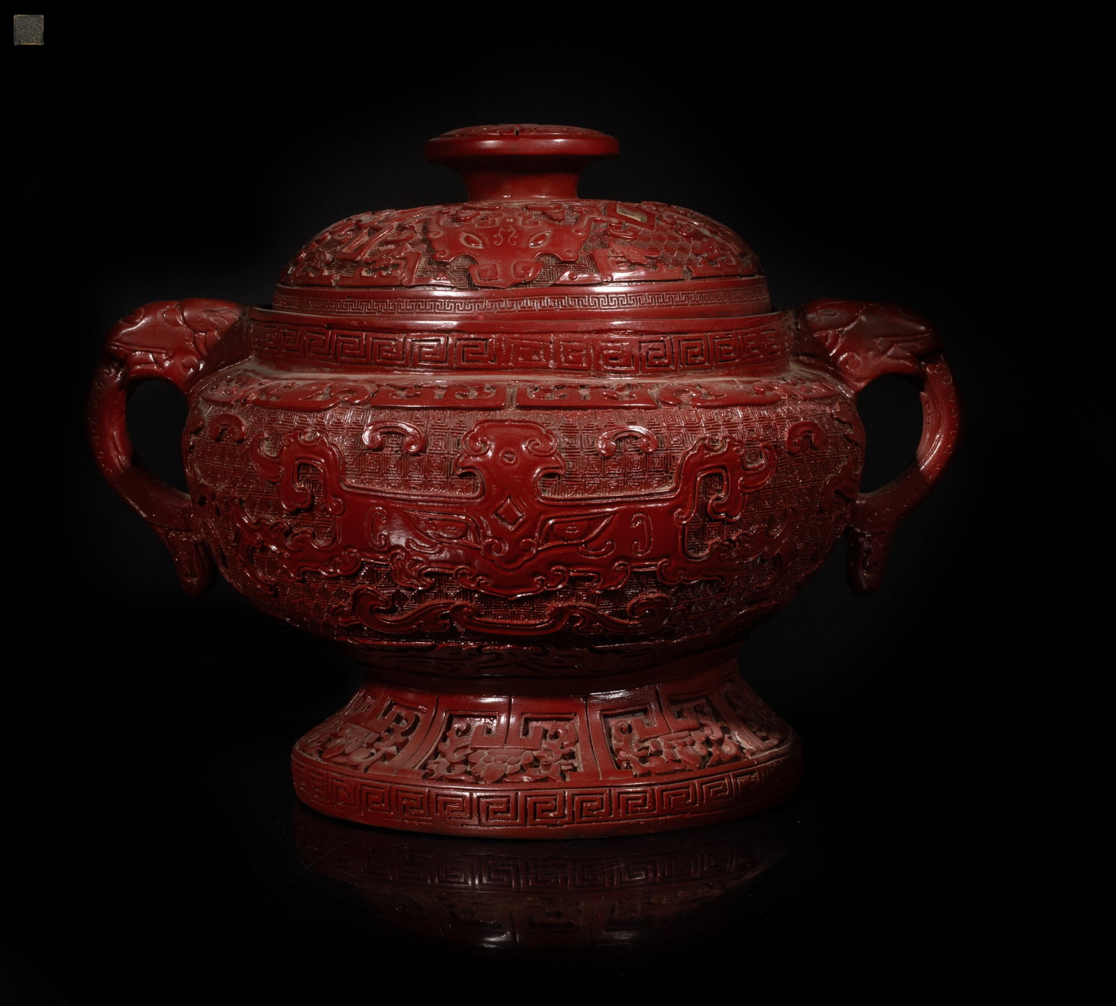 Large Chinese Cinnabar Covered Pot: Large Chinese cinnabar covered pot carved with archaic masks on leiwen ground, the bottom with seal mark. Approx. 10*12.5*9.5 inch.