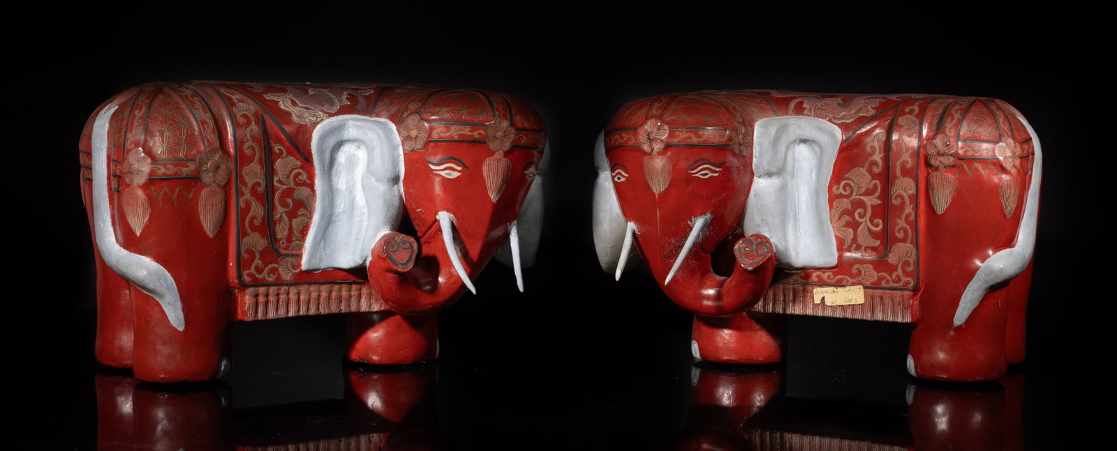 Two Chinese Lacquer Elephant: Pair of elephant with four feet in standing position, its head turned slightly left, applied overall in red tone, highlight with gold-tone pattern. Approx. 12.3*7.6 inch