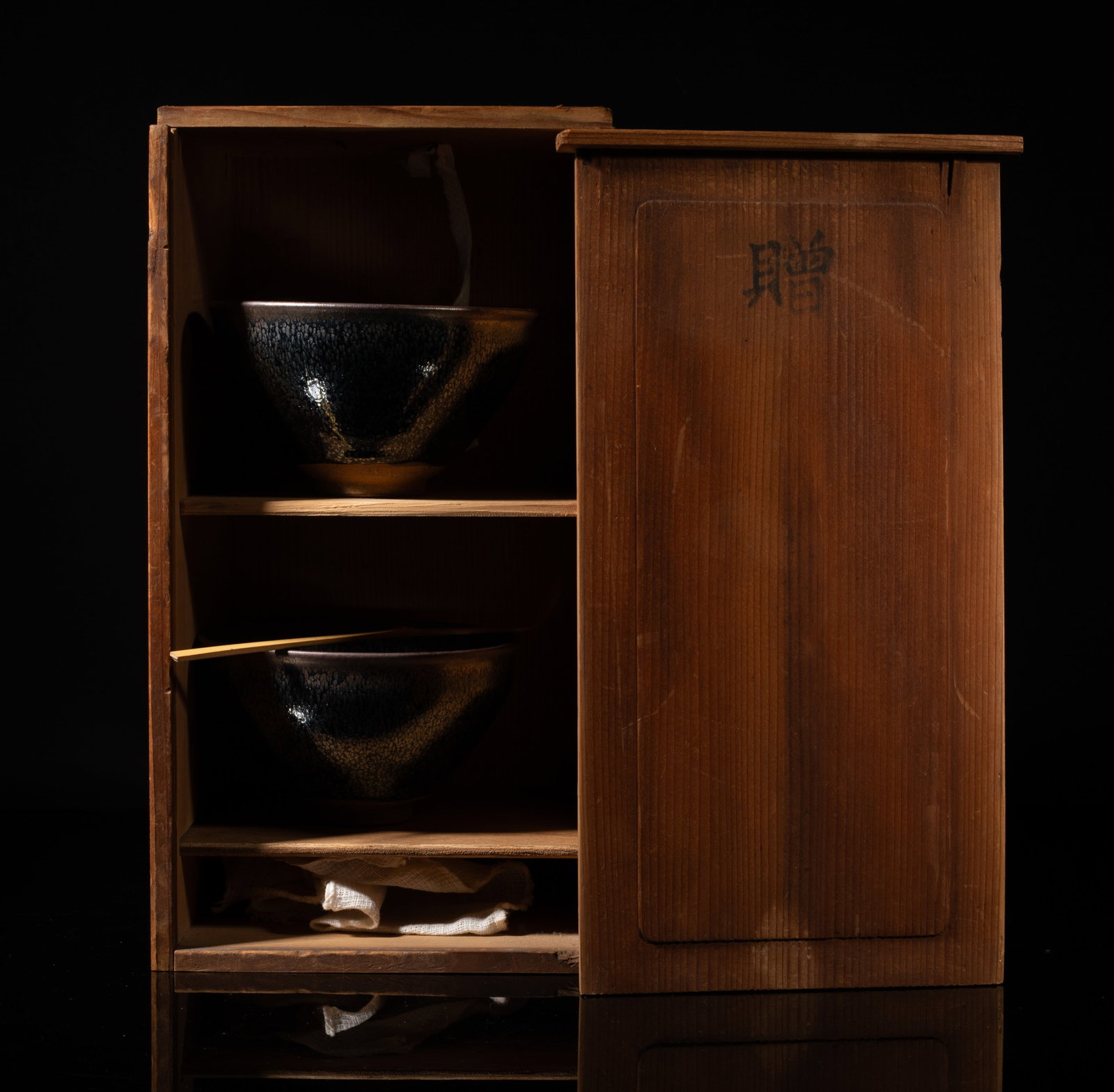 Set Chinese Jian Stoneware Porcelain Tea Bowls: Two Chinese Jian type stoneware porcelain tea bowls, with wood case. Approx. 4.9*2.8 inch (larger bowl size). The Estate of the Mark Oliver. Los Angeles. 1998.
