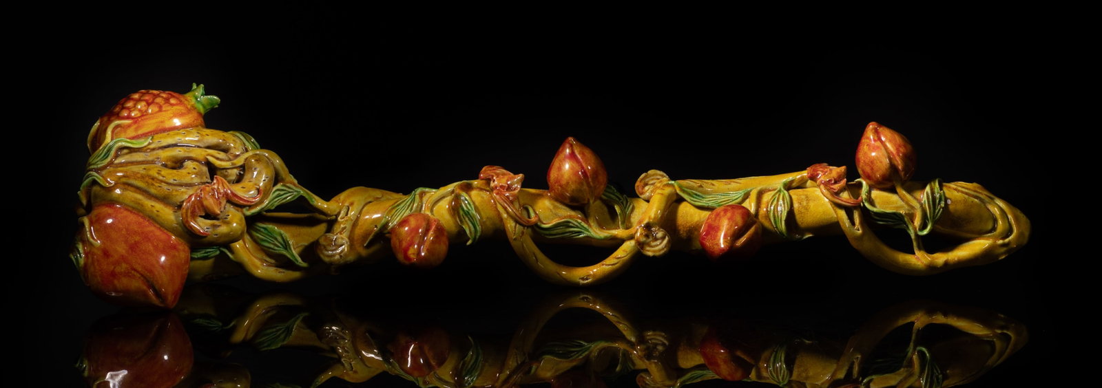 Special Chinese Porcelain Sculpture of Ruyi: Skilfully carved as a peach branch surrounded by delicate twisted branches with leaves, embellished with peaches, lingzhi fungus and bats, the head formed as a peach, a pomegranate and a buddha hand c