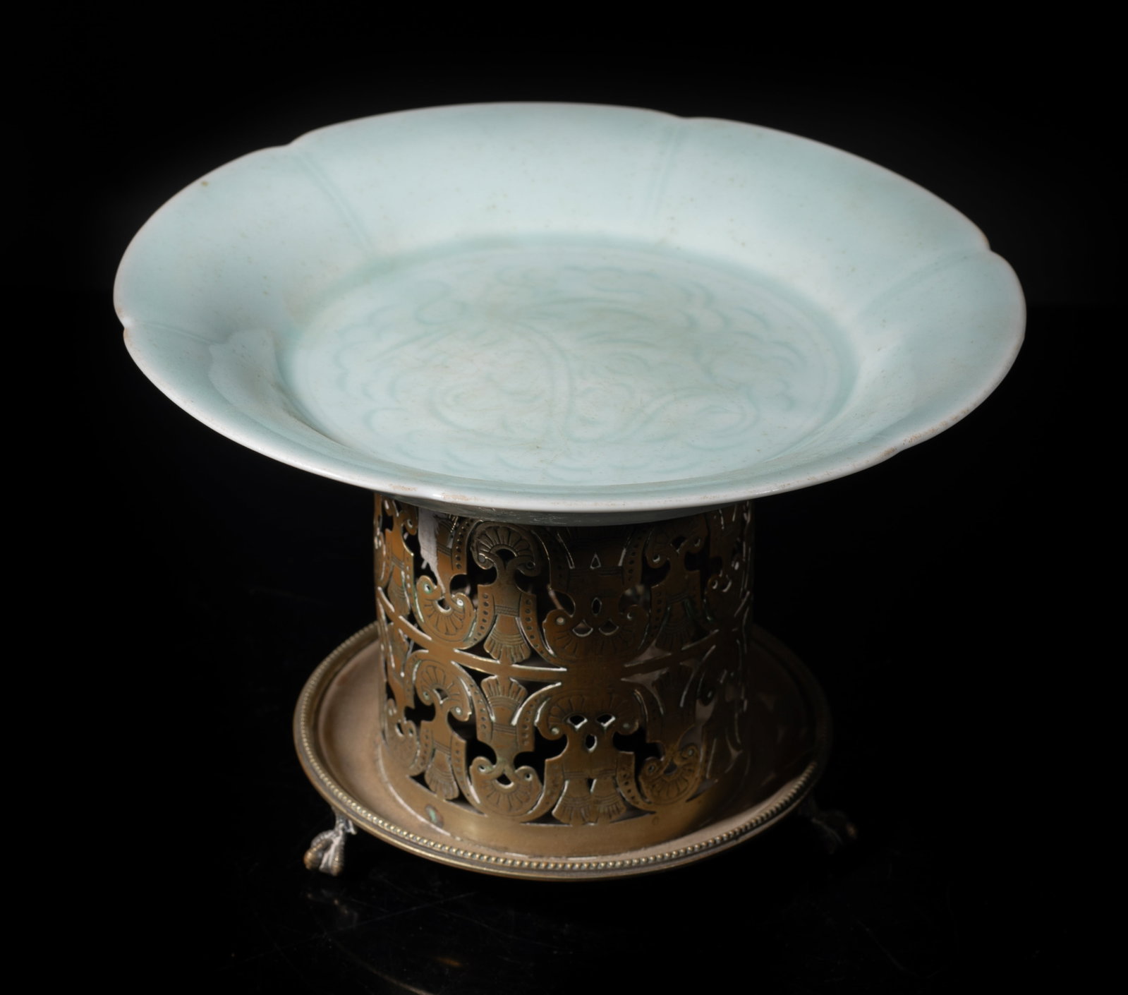 Chinese Hutian Porcelain Plate W/ Base: Chinese Hutian pale sea-green glazed porcelain plate, with tall metal stand. Approx. 8 inch D (plate size). The Estate of the E Los Angeles, CA, 2022.