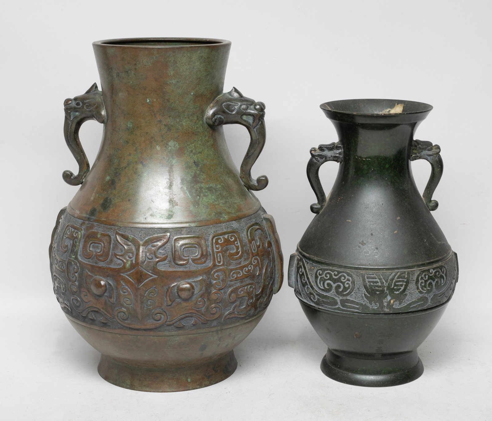 Vintage Japanese Metal House Decor Vases: Two vintage Japanese metal room decor vases, each cast with archaic beast or mask patterns. Approx. 11.5*8.2 inch (larger).