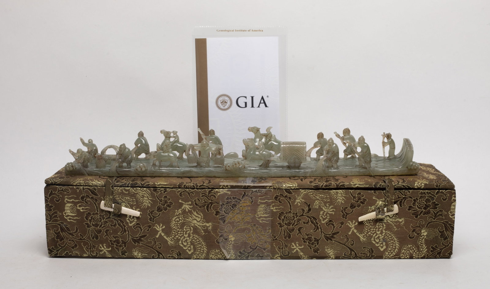 Chinese Export Jade Carved Boat Sculpture: Chinese jade bamboo raft sculpture, carved with figures in various activities, the underside incised poems and seal marks, with GIA certificate, and box. Approx. 14.5*2.8*1.7 inch (w/o box).
