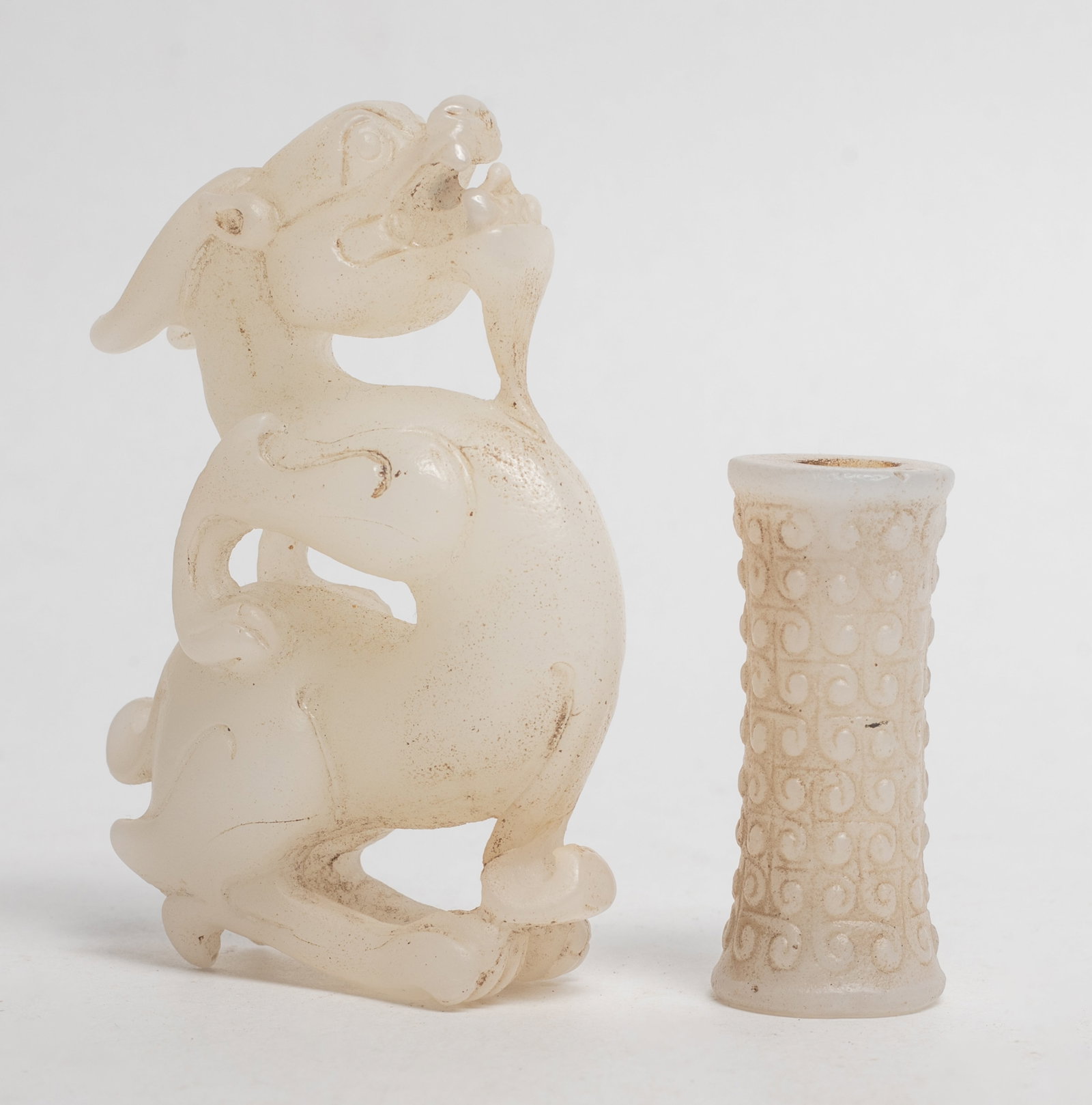 Two Chinese Jade Like Glass Carvings: Chinese jade-like glass bead and stylized beast sculpture. Approx. 3.25*2.2*0.9 inch (larger).